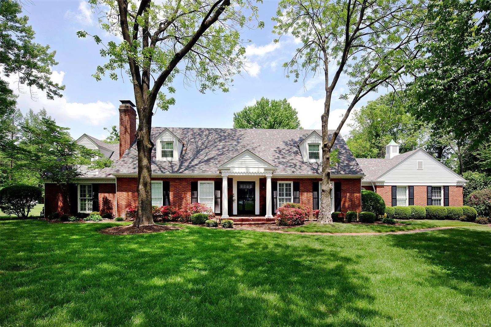 NEW PRICE! NEW PICS! FRESH NEUTRAL PAINT THROUGHOUT! This attractive 1.5 story home is situated on an acre lot in the heart of Ladue. 2 sty entry foyer w/slate tile flr opens to light-filled formal liv rm w/gas frplc & built-ins. Din rm has bay window & swing door leading to fabulous kitchen w/center island, granite & custom cabinetry. Lrge vaulted breakfast rm off kitchen opens to cozy sitting rm w/ skylights & beautiful views of the tiered deck w/pergola & saltwater pool. Family rm has wet bar & gas frpl. Main flr master suite has walk-in closet,  separate door leading to back deck & attached office. Access the 2nd flr w/ front & back stairs leading to 4 spacious bdrms, 2 updated bths & a loft area perfect for the kids.  The LL offers a lrg rec rm w/gas frplc, play rm, full bath & laundry rm.  Gleaming hrdwds, plant shutters, built-in lockers in mudrm, plenty of green space. Newer roof/ maintenance free deck & pergola/ updates to pool & 2 new baths upstairs. New floor in LL.