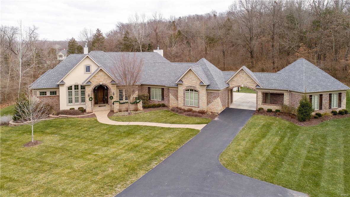 Luxurious Estate Home blended with Comfortable Family Living describes this Fully Custom Executive Ranch Masterpiece in in the highly desirable Homestead Estates!. Impeccable detail Throughout! Masterful Design features every amenity one could want. From Grand Entry, Elegant Dining Room, to the Luxurious Master Suite, and phenomenal Master Bath featuring a centerpiece Jacuzzi tub, to the Ultra High-end Cooks Dream Kitchen & Fabulous Hearth Room featuring stone fireplace to the Elegant Great Room with Unbelievable Bar! 4 nice size secondary bedrooms 2 w/ their own bath, to the unbelievable lower lever featuring a Custom Bar, Game Room, 2 Bedroom, Magnificent Theatre Area, Game Room, Wine Cellar. Then walk out to your own private oasis of entertainment and fun! Pebble Tec Saltwater Pool with expanded decking and putting green. Phenomenal huge private 3+acre level lot perfect for future sport court. 4 car Garage with Porte Cochere. Ultra high end finishes throughout! This place is AWESOME