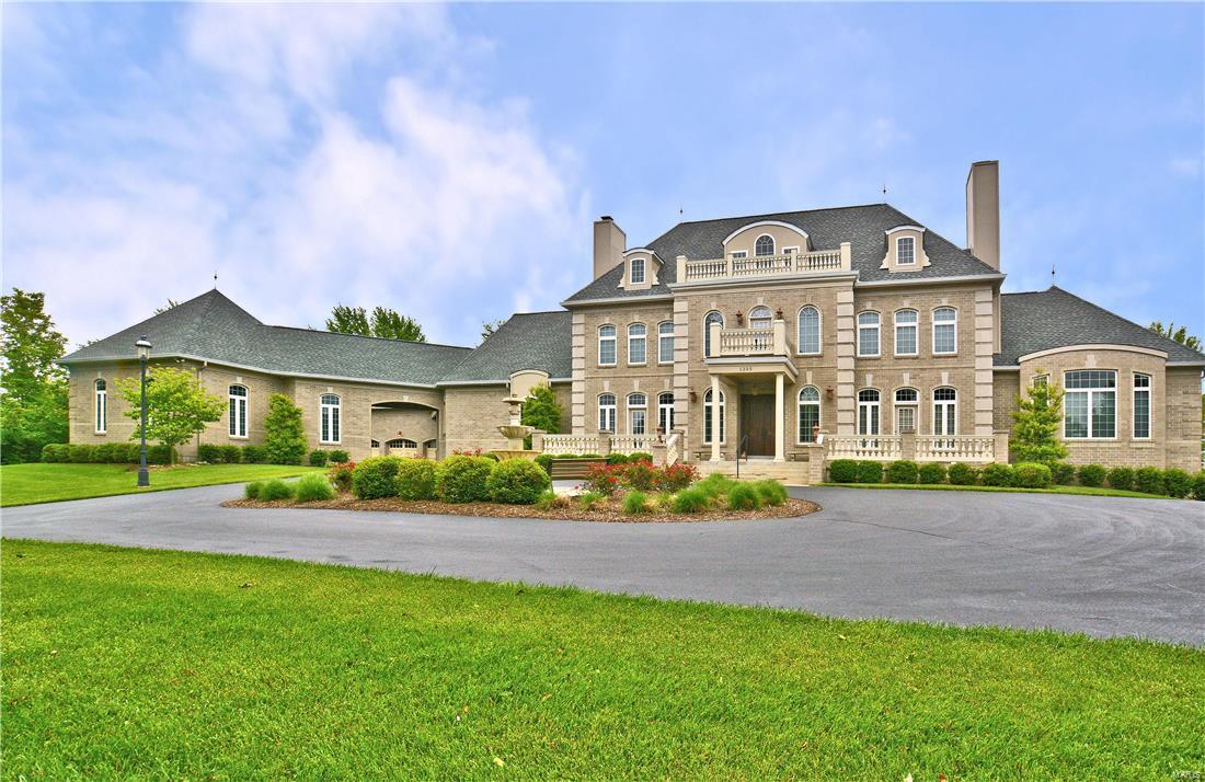 This one-of-a-kind amazing custom home with over 7,000 square feet of living space is first time on the market for a family who is looking for just about everything you would desire in a home.  It is an all brick French style Chateau home that comes with 7 oversize garage spaces. It has geothermal zoned heating and cooling, and energy efficient low-e argon commercially tinted windows which equates to very reasonable utility bills. The list just goes on and on.  His and her master bathroom suite, a custom kitchen with modern cabinetry, and high end appliances and built-in refrigerator.  All granite counter top surfaces in kitchen, bathrooms and laundry room. Some slate flooring, marble flooring, and hand scraped wood plank flooring.  Whole house music system, 10 foot deep pour foundation, extensive mill work and built-ins, two custom curved staircases. Second kitchen, bath and in-law suite, theater room, 600 amp electric service, inside elevator, in-ground saltwater pool, new roof, wow!
