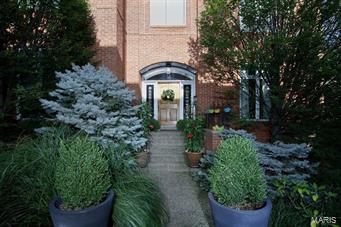 Find sophisticated urban living within blocks of the Clayton business district.  Truly a unique opportunity, this residence has been beautifully and elegantly updated within the last few years.  Every space has been thoughtfully conceived.  You will discover a two year old gourmet kitchen customized for entertaining with designer appliances including double ovens and two dishwashers.  The living room is accented with a dramatic fireplace surround and mantle.  Oversized windows infuse light to every level of living area. The kitchen opens to an intimate hearth room and a private deck.    The windowed lower level walks out to the terrace set within a lush and secluded garden.  The fabulous master suite includes a fireplace, 3 organized wall closets plus a huge walk-in closet and luxurious bath.  At every turn, the home offers impressive attention to detail.