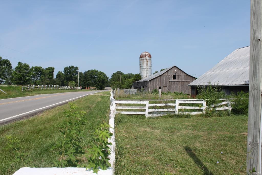 This 155 +/- acre piece of land is located just south of Wentzville. Property feels like you're in a secluded area, but only 5 minutes from the movie theater. Farm consists of around 65 acres of farmland, 25 acres of pasture, a lake about 6 acres in size, with the rest comprised of woods. Rural water runs along the road. Farm has great road frontage and has ample opportunity for future development in the Wentzville area.