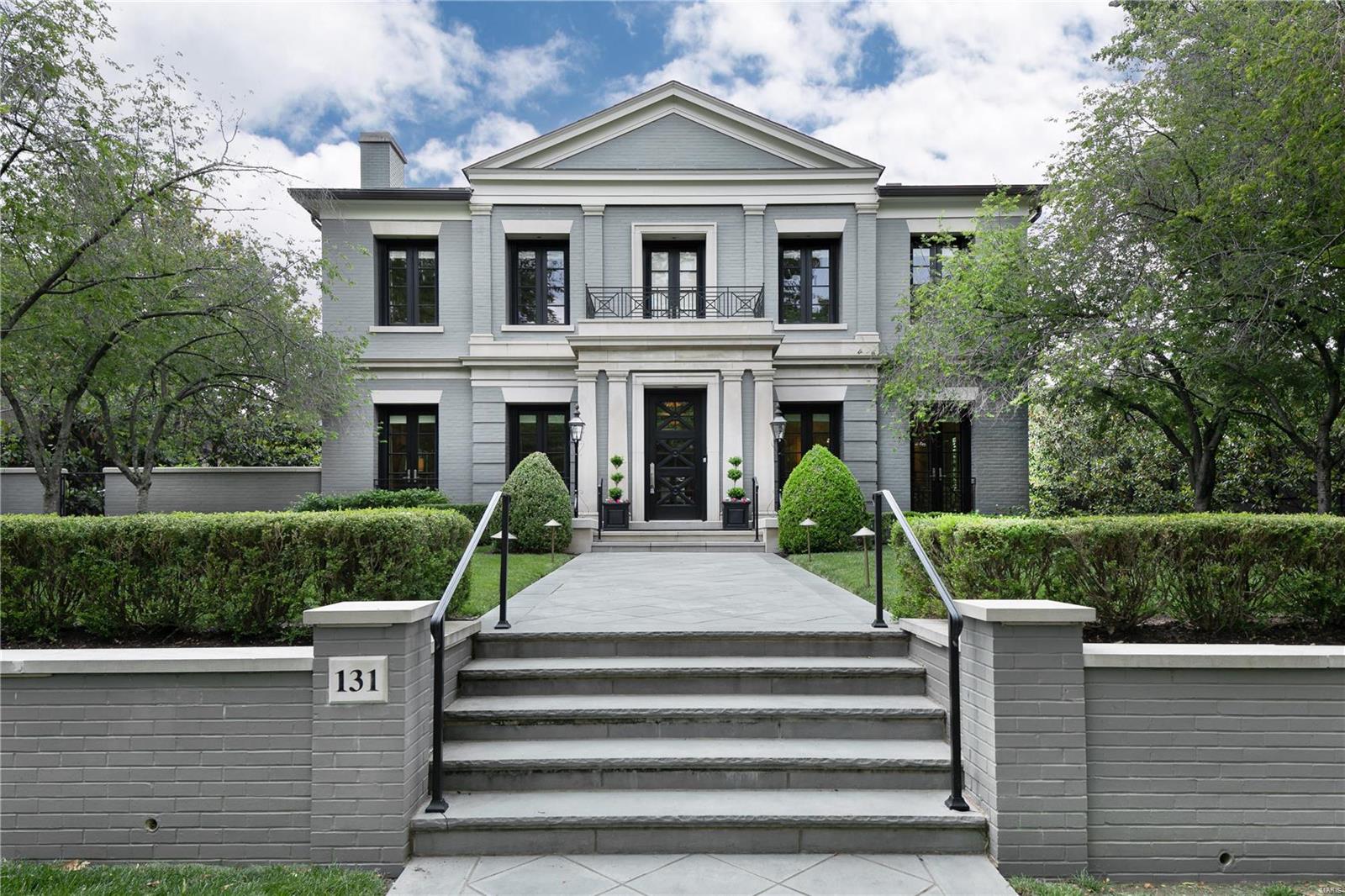 Stunningly handsome residence with stately presence on premier street in Old Town Clayton! This outstanding home is situated on one of only a few 100 foot wide lots. 10 ft ceiling heights, 8 ft doors, elevator to all floors, hardwood flooring throughout, 3 gas fireplaces, radiant heated driveway, whole house Kohler generator, central vac, pool, screened porch, 3 car heated garage (2 spots tandem).  Enter through impressive 40 ft gallery hallway to find on the main level Living Rm, Dining Rm, Library, Family Rm open to Kitchen with Butler's Pantry, 2 half baths. Screen porch, covered terrace and side terrace.  Upstairs has 3 bedrm suites and laundry. Expansive balcony terrace off large primary suite with remote control awning  Huge closets. 20 sets of Marvin French doors, most w Phantom screens. Lower Level features 4th Bedroom w walk out door, Kitchenette,  Full Bath, Family Room, built in Office, Laundry, and Garage access. 22 x 16 Gunite pool, limestone fountain, lovely fenced yard.