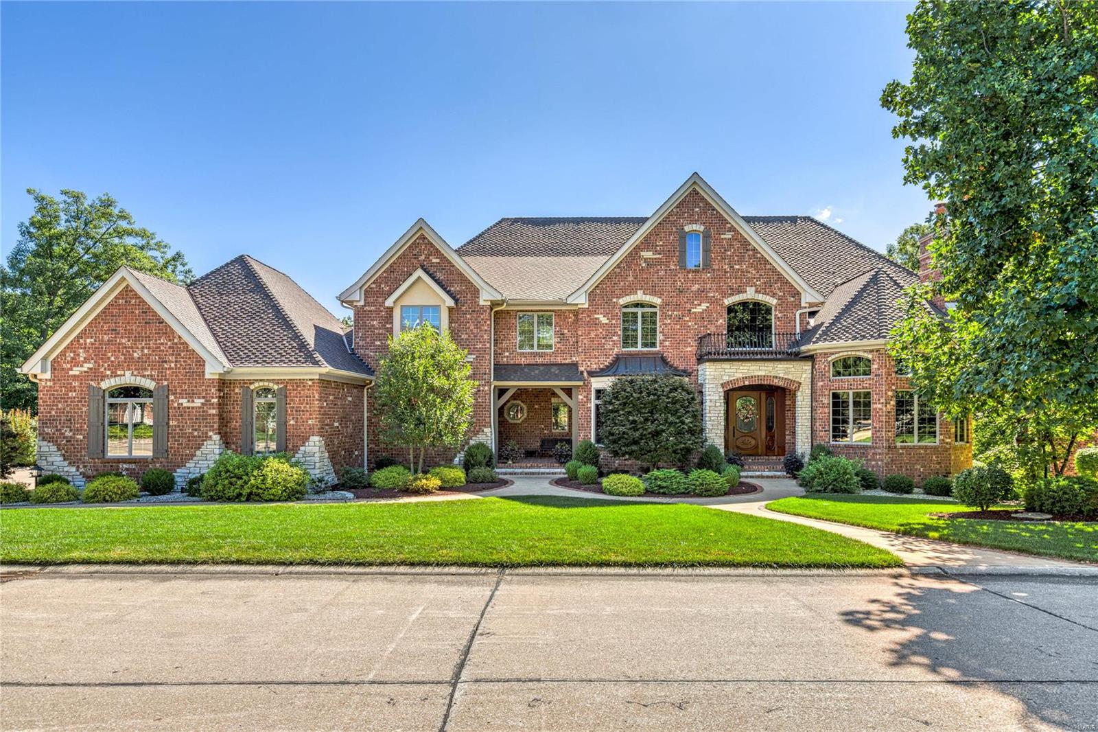 Magnificent 8900 sf Schaeffer-built Estate home situated on a spectacular lot on the bluffs of the Missouri River. 2-Sty marble foyer with dramatic curved staircase opens to handsome library with 14’ box beam ceiling & fireplace with oak mantel, elegant dining room & stunning great room with marble fireplace, wet bar & wall of windows with unsurpassed views.  Designer kitchen with granite countertops, 42” custom cabinetry & commercial grade appliances adjoins breakfast room with dimensional ceiling, bay window & atrium door to screened porch & vaulted hearth room highlighted by floor-to-ceiling stone fireplace. Primary bedroom suite with wide bay window & lavish bath with shower spa & Jacuzzi offers an appealing retreat. Front & rear staircases access 3 ensuite bedrooms & loft sitting area. Walk-out Lower Level features recreation room with wet bar & 4th fireplace, media room, office, 5th & 6th bedrooms & 1 ½ baths. Grounds include private deck & patio surrounded by landscaped gardens.