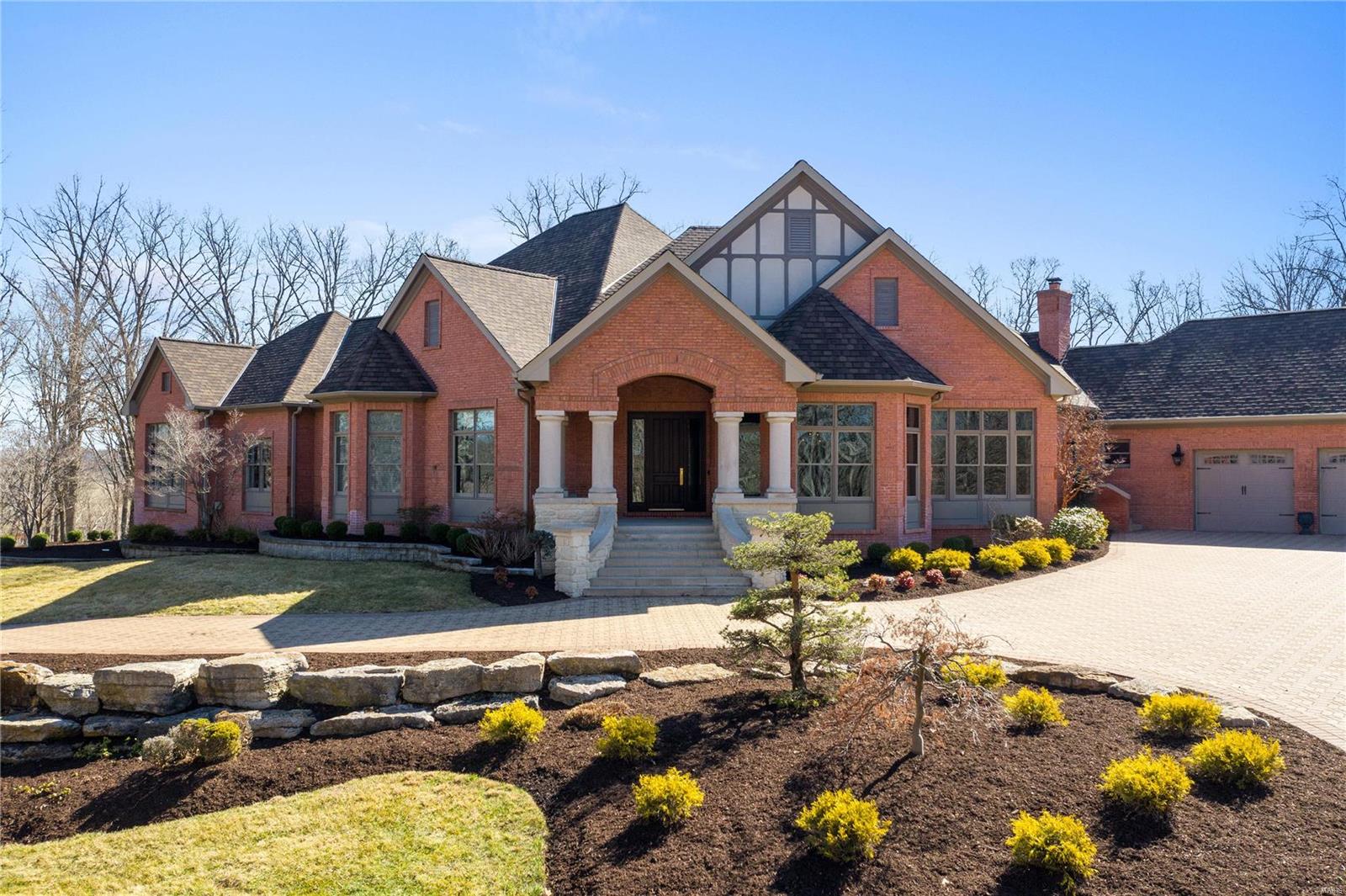 Handsome, fully-updated traditional, half-timbered house with limestone exterior detailing on an incredibly private 11+ acres with a stocked pond for fishing. Only a short drive to beautiful St. Albans. High-efficiency geothermal heating and cooling. Open floor plan ranch, ideal for entertaining with chefs kitchen, all Wolf & SubZero appliances, custom cabinetry, quartz countertops. Serving room adjacent to kitchen and dining room has custom island with ample space and built-in wine/beverage cooler. Hearth and breakfast space open to kitchen with floor-to-ceiling windows for terrific natural light. Media room with stadium seating and powered leather recliners. Custom-designed pool with cave, multiple waterfalls, beach entrance. All five bedrooms en-suite. Lower level billiard room with full bath, walk-out access to pool and expansive workout space. Sprawling paver drive with 6 car garage. Horse property not included with this sale, but owners would consider selling additional acreage.