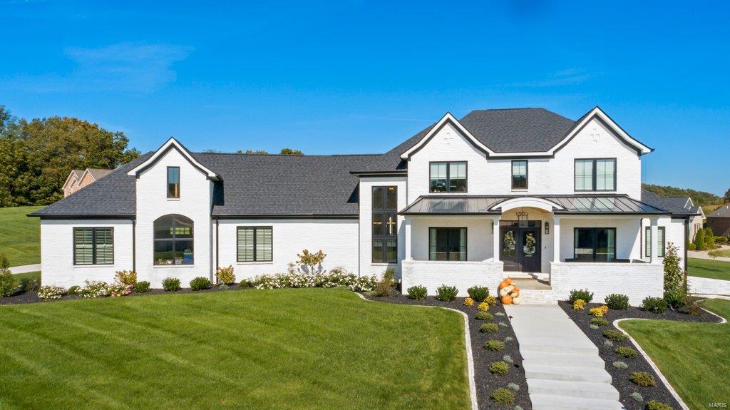 THIS SPECTACULAR HOME is magazine cover worthy!  It boasts the latest design trends reflected in the unique lighting, wood flooring, intricately tailored kitchen and baths...You name it, this home has it all!  The floorplan is flawless and so is the beautiful finish work.  The kitchen abounds in custom cabinetry with Big Chill Professional Series appliances. and walnut wood touches that adds to it's uniqueness. Two stone laden gas fireplaces inside the home and one stone gas fireplace on the covered patio add to the warmth and atmosphere when entertaining or for just relaxing at home.  The upstairs is so very spacious with a stylish living area, in addition to the comfortable bedrooms and baths.  The vibrant landscaping and expansive outside lighting system showcase the outside of this home perfectly. There is a  Vivient Security System, a rear entry oversized three-garage, and the list just keeps going! This is definitely a "one of a kind" custom home that is absolutely beautiful!!