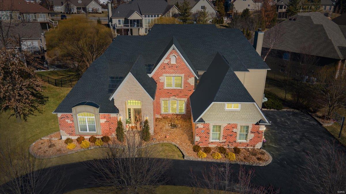 This stunning, custom-built home offers apprx 7,000 sqt of luxurious living space, situated on an oversized corner lot w/ a circular driveway in a gated community, this exquisite residence features a 3-car gar, Roof (2/21), new fence,new LVP fl & an incredible new pool w/ heating, lighting, a waterfall & patio.The grand 2-sty foyer boasts soaring ceilings & is flanked by a den & formal DR.A breathtaking great rm showcases a 2-story wall of windows.The gourmet eat-in kitchen includes a bkfst bar, a massive curved center island, custom cabinetry, granite countertops, SS appl & flow into a cozy hearth rm w/ a stone FP. The main-floor master suite offers a whirlpool tub, a sep shower, His/ Hers vanities & a spectacular walk-in closet. Upstairs, you’ll find 3 addtl BR, all w/ walk-in closets—1 w/ an ensuite bath & 2 sharing a Jack/Jill bath. The fully finished LL is an entertainer’s dream w/ a theater room, a spacious game rm, a workout rm, an office, a bonus rm & an addl full kitchen 2022.