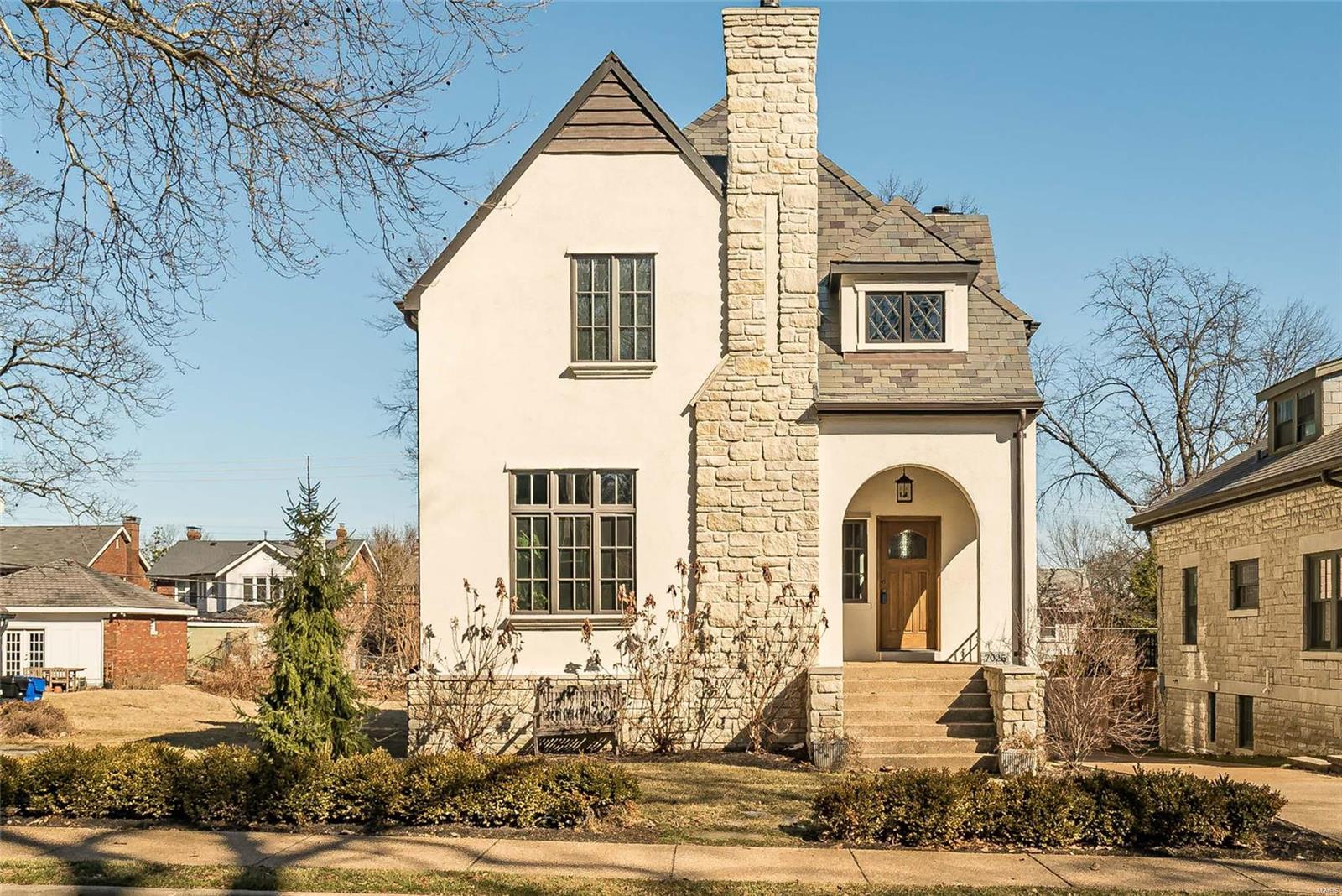Absolutely stunning 4 bedroom / 4 bath home reminiscent of a historic English manse BUT custom built by Period Restoration LLC in 2016 with all the modern amenities desired by today's buyers. Gorgeous curb-appeal including stucco and stone finishes, slate roof, two stone chimneys, copper gutters, newer decks off the main level and private deck off the primary bedroom suite. There are custom finishes throughout including hardwood doors, custom trim, vaulted ceilings, dumbwaiter. wood floors throughout and high-end kitchen appliances. The home features the best of both worlds...lovely entertaining space including both living and dining rooms. Additionally, the open floor plan including a gourmet kitchen, hearth room with fireplace, breakfast room all with immediate access to the deck off the back of the home. This home is located in Forsyth Place on "Little Lindell" close to Wash U, Forest Park and 5 minutes to the heart of Clayton. Main level laundry and 2 car oversized garage.