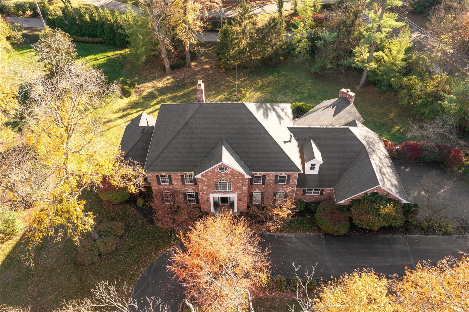 Stunning Ladue estate on private acre+ lot, is an entertainer's dream! Built to appease the most discerning eye, the gracious 7200+sf floor plan is suited for grand formal parties, yet cozy enough for quiet family dinners. Enter the 2 story foyer with twisting staircase and marble floors, and marvel at the view of the great room, with 25' ceilings, elegant fireplace, 2 story windows with custom millwork, all overlooking the tree-lined lot. Entertain guest in the formal dining, retreat to the library, or gather round the hearth in the open kitchen/family room. Fit for any chef, the kitchen features custom cabinets, side-by-side fridge/freezer, double ovens and dishwashers, butler's pantry, separate walk-in pantry. Primary wing features bath with dual vanities, WC, jetted tub and dual walk-in closets. Walk-out LL rec room boasts pub-style bar, movie theater, gym, MIL suite and fireplace. Also featured: 3 upper beds, 2 more full/2 half baths, playroom, main floor laundry, 3 car garage.