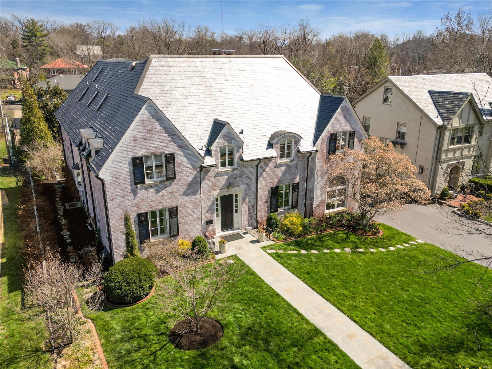 Located in Clayton’s historic Claverach Park, this 4 bedrm, 4 full and 3 half bath home radiates the graciousness and bespoke details that you would expect to find in Clayton.  The seamless 3 story addition contributes to the designer finishes and updates perfect for today’s busy lifestyle.  The formal living rm, dining rm and office give way to a light filled large open kitchen with butler’s pantry, custom cabinetry, stainless appliances and gorgeous stone counters.  The large wood beamed family rm is surrounded by windows and walks out to a private deck.  Upstairs an extra-large master suite with detailed ceilings, dressing area with ‘coffee’ bar and large walk-in closets provide a perfect sophisticated retreat.  3 large bedrms, 3 custom baths and a laundry rm complete the 2nd floor.  The expanded lower level offers a mudrm, playrm/rec rm, extra family rm and half bath.  Private landscaped yard with fountain.  Updated systems including geothermal also found at this special property. Additional Rooms: Mud Room
