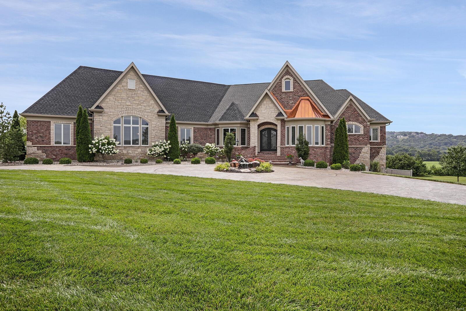 One of a kind newer construction custom luxury ranch home on over 3 acres of resort like setting. Walk in through hand crafted iron double doors and get ready to be wowed! Inside you'll find exquisite millwork throughout-extensive crown molding, triple tray and coffered ceilings, arched openings and bullnose corners. Great room w/floor to ceiling windows offer panoramic views. STUNNING CHEF'S KITCHEN features dual dishwashers, oversized island w/prep sink, massive breakfast bar and beverage center w/cooler. The master suite opens to an exquisite luxury bath w/dual vanities & 2 walk-in closets. An oversized 4 car garage rounds out the main level. A custom curved staircase leads way to an additional 2500 sq ft in finished lower level with a 10ft pour, 4th bedroom, full bath, media room, family rm & bar. Walk out to a custom designed pool w/an extensive pool deck. Irrigation system,3 zone HVAC & so much more. Close to I44 & 270, in ROCKWOOD Schools & a golf cart ride from 3 golf courses. Additional Rooms: Mud Room