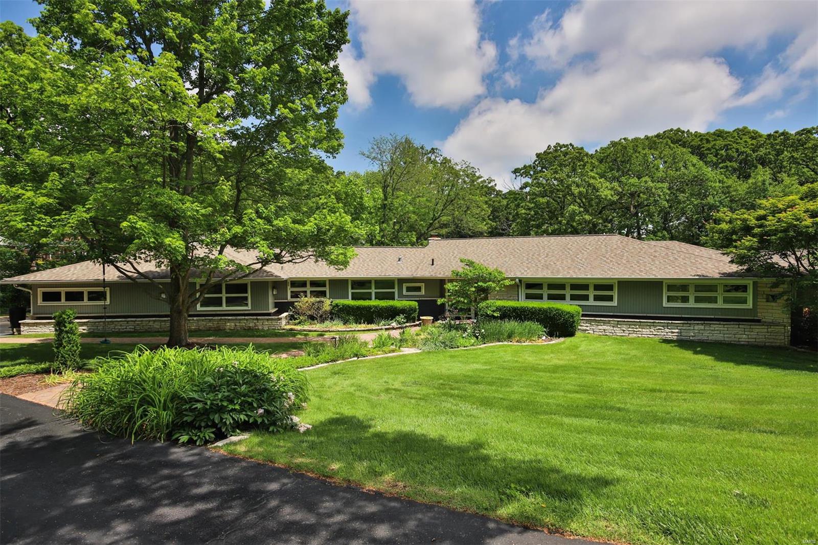*NEW ROOF *Nestled in a cul-de-sac with prestigious Ladue Schools, this Mid-Century Modern Prairie home is an architectural gem! Spanning a lush 1-acre lot, property boasts award-winning botanical garden which offers a picturesque retreat. The residence features a stunning Saltwater pool with a dedicated lap lane, perfect for fitness enthusiasts and leisure swimmers alike. The home seamlessly blends indoor & outdoor living with an elegant glass-enclosed sunroom, providing a tranquil space to enjoy your beautiful surroundings year-round. Top-of-the-line appliances, center island, and ample counters grace the generous Gourmet Kitchen, crafting a culinary experience. Relaxation is paramount with a luxurious whirlpool tub & sep shower in primary suite. Property includes a well-appointed mother-in-law suite, ensuring privacy and comfort for guests. Combination of classic Mid-Century charm with Modern amenities, makes an unparalleled residence in a prime location. Additional Rooms: Sun Room