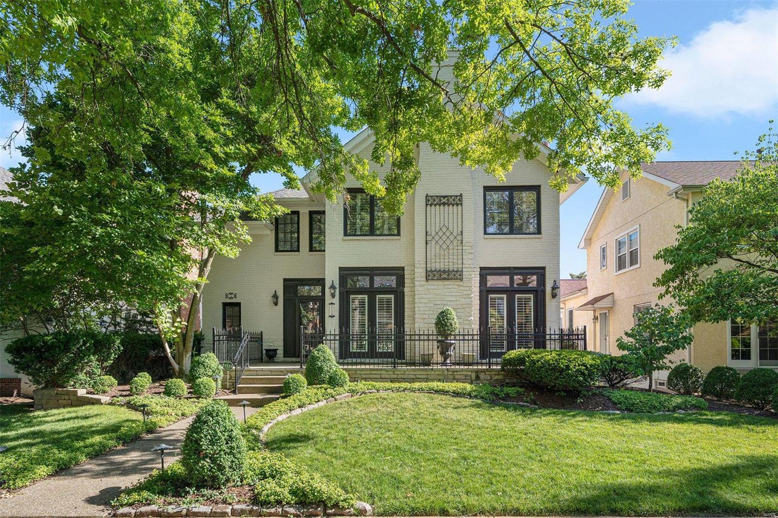 The best of urban living in a suburban setting. A walk out the back door leads you to fabulous restaurants and shopping in downtown Clayton, while the front brings you into the quiet neighborhood of beautiful Clayton Gardens. The gracious curb appeal beckons you into the ample entry hall, which flows seamlessly into the living room with gas fireplace, french doors, and 10' ceilings (found throughout the 1st floor). There is plenty of prep space in the custom kitchen with high-end appliances, new tile backsplash, and counter seating. The family room boasts another fireplace and french doors to the Pergola-covered deck, overlooking the level yard with water feature. Ride the elevator up to the 2nd-floor Primary suite with office nook, Juliet balcony, and walk-in closets. There are three additional bedrooms and a walk-out lower level with full bath, wet bar, and media/sleeping room with Murphy bed. Special deck ceiling for 3rd car. It's time to enjoy the most walkable Clayton lifestyle!