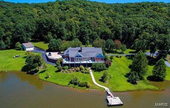 Exquisite ranch home on 242.73 acres with 10 stall horse barn, outbuildings and 24 acre lake. This home has an up to date eat-in kitchen, living room with wood vaulted ceiling, large foyer, wood flooring throughout and separate dining room with wood trim. The home has ample space with 5,000 sq. ft. of finished living area. The lower level offers huge recreation area, card room, wood bar, kitchenette, family room & double-sided stone fireplace. There is a full-length deck to accommodate large gatherings with a breath-taking view of the lake. The master bedroom suite has a coffered ceiling with fan, large closet and French doors leading to the deck. The nice master bath has dual wood vanities and a separate tub & shower. The unique horse barn has 10 separate 12 x 12 stalls, wash room, tack room, 2 foaling stalls, large office, kitchen and lounge. This property offers many extras, numerous outbuildings, lots of privacy and plenty of acreage in a great location close to Hwy U & Warrenton.