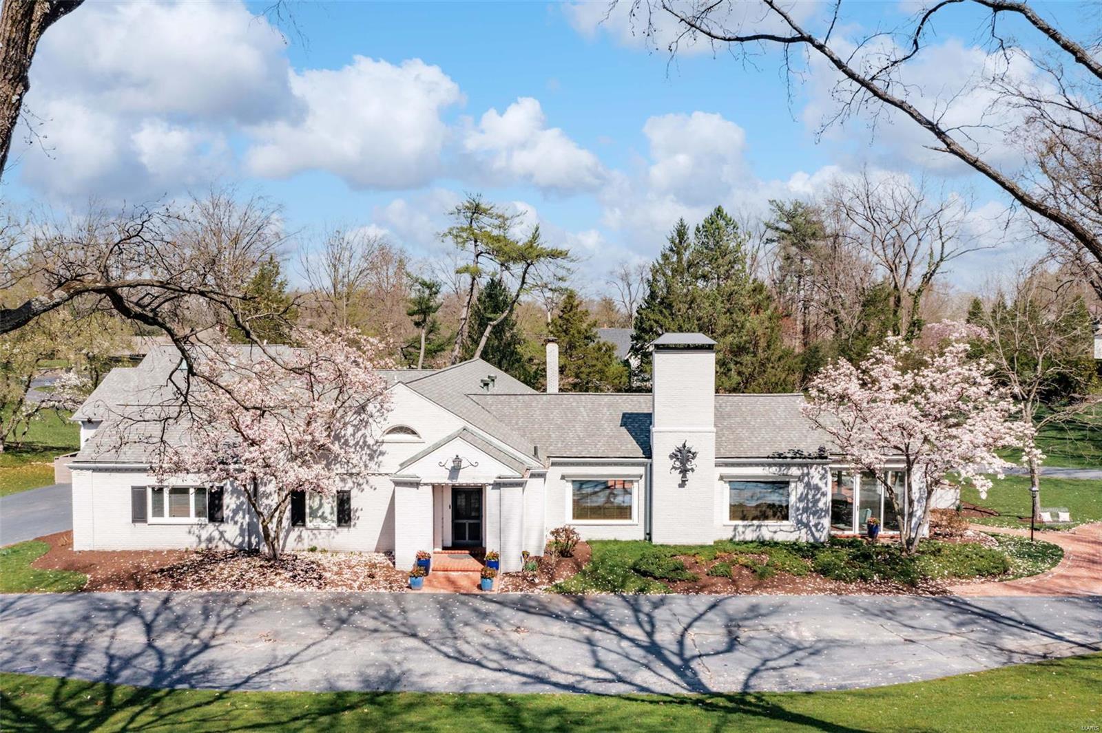 Discover refined sophistication in this breathtaking Maritz & Young masterpiece, gracefully set on 1.46 acres in the heart of Westwood, one of St. Louis's most coveted neighborhoods. With 5,429 sq ft of timeless design, this 5-bedroom, 5.5-bath home is a seamless blend of classic elegance and modern comfort. Soaring ceilings, rich architectural details, and an open, sun-filled layout create an atmosphere of effortless luxury. The main-floor primary suite offers a tranquil escape, while the chef’s kitchen features high-end appliances, custom cabinetry, and a walk-in butler’s pantry. Entertain with ease in the elegant dining room, inviting great room, or expansive family and game rooms. A stunning sunroom and sweeping patio invite indoor-outdoor living, surrounded by lush, manicured grounds. Located just moments from everything—shopping, dining, and top schools—this extraordinary home delivers rare architectural pedigree and everyday livability in one iconic address. Some Accessible Features