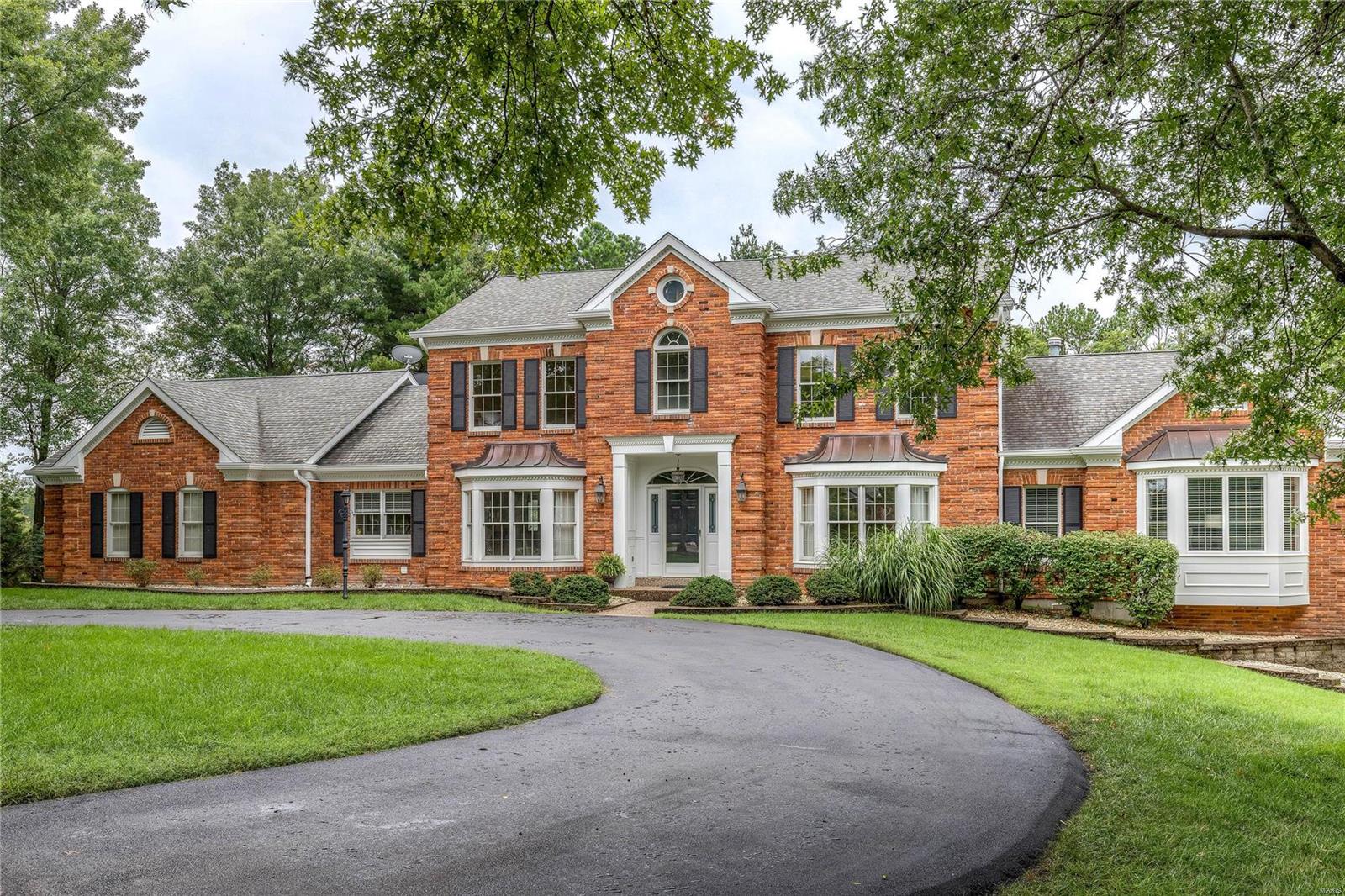 Classic-styled brick 1.5 Sty on 1-acre grounds! Over 5500 sf of living space enhanced by rich hardwood & marble flooring, extensive millwork & custom built-ins. Impressive marble foyer opens to formal living & dining rooms with elaborate molding & wide bay windows & spectacular 2-sty family room with floor-to-ceiling brick fireplace, wet bar & dramatic wall of windows. Designer kitchen with 42” cherry cabinetry, granite countertops & Viking appliances adjoins breakfast room with 9’ sideboard & atrium doors to patio. Coffered master bedroom suite offers a relaxing retreat with His & Hers walk-in closets, luxury bath with jetted tub & private office. The 2nd floor extends the living quarters with 3 generous-sized additional bedrooms, 1 with ensuite bath & 2 with Jack n’ Jill bath, plus loft sitting area. Expansive Lower Level includes family room with fireplace, recreation room, 2nd kitchen, office, workout room & full bath. Situated on a premium cul-de-sac lot with patio & 3-car garage.