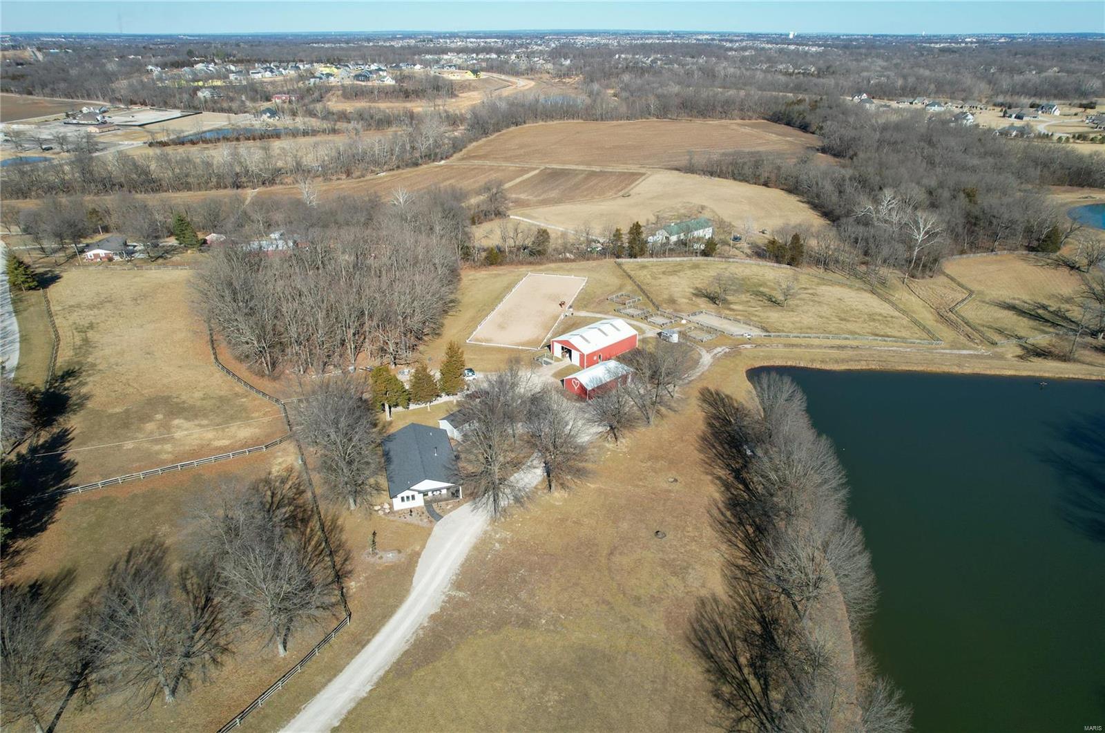 Stunning Equestrian property on 25+/- acres with a newer 1800+/-SF home of exceptional quality with cathedral ceilings in the living areas and 9ft ceilings in the bedrooms.  Covered stamped concrete patio overlooks a 3-acre, spring fed, stocked lake. Just off the back of the house sits an additional one room "bunk house" perfect for guests. A 24x51 concrete block building currently serves as storage for a tractor, up to 800 square bales, and has a separate workshop/storage space. The Horse barn measures 40x60, includes 4 oversized foaling stalls, 3 11x11 stalls, tack room, and a 3/4 bathroom. Multiple paddocks and turn-outs, 9 acres of fenced pasture in total, Outdoor all weather 20x60 meter riding arena and the list goes on.  Fantastic location, just minutes from shopping and amenities. (10 mins to Winghaven, 20 mins to Chesterfield Valley) Come see what you have been looking for! Duplicate listing of MLS #23007101