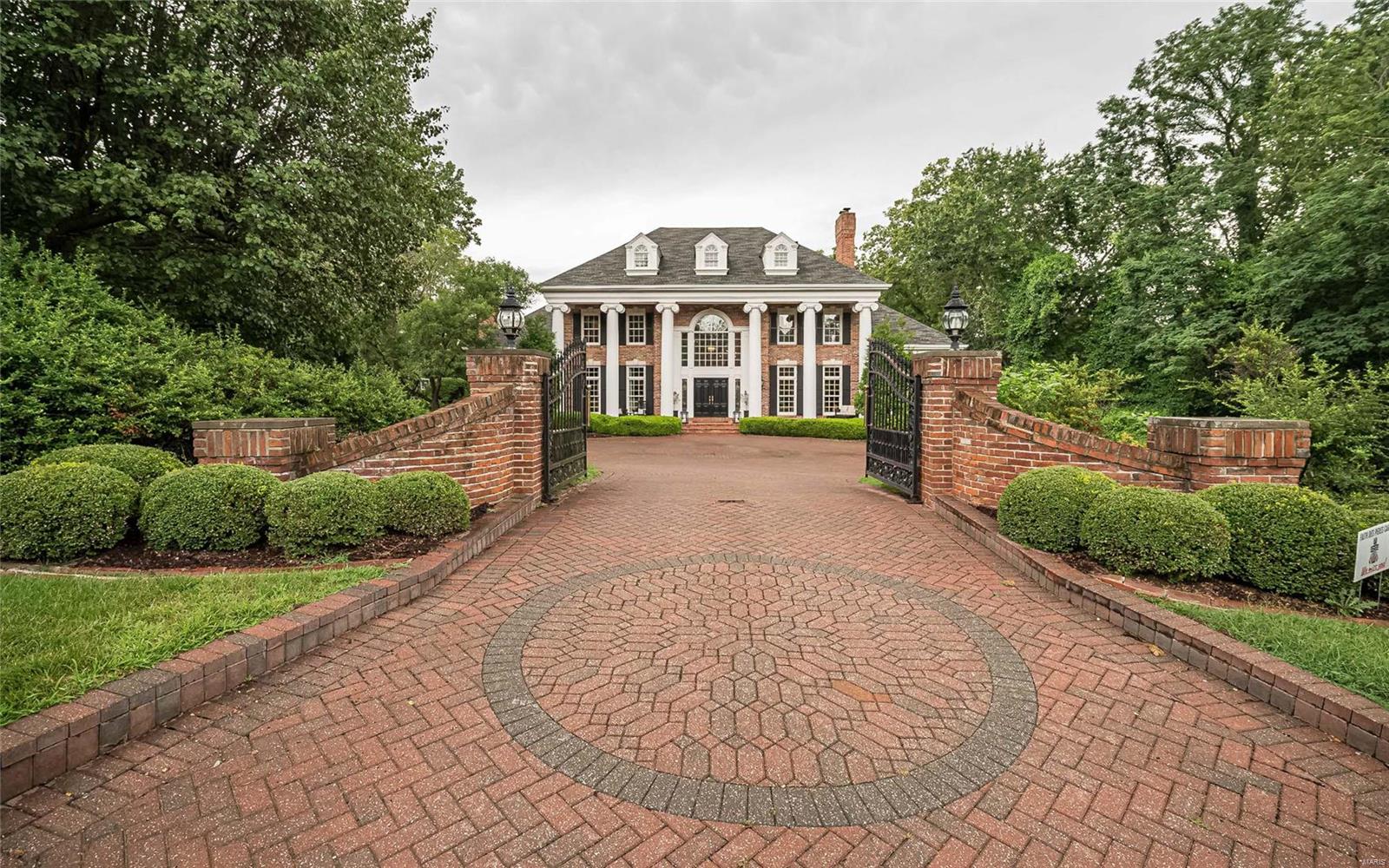 Executive home has been beauitfully reimagined by the current owners. Vacation every day in this amazing estate. Gated entrance leads guests to the 2 story grand entance. Sophisticated great room has soaring ceilings, many windows, bar and impressive view of the newly created resort like back yard and pool.  Formal dining room & den boast fine appointments. The expansvie kitchen has custom Crystal cabintery, center island, breakfast bar and opens to the breakfast & hearth rooms. Impessive custom ceilings thrughout the home. First floor master bedroom suite has his/her closets. 2nd floor boasts 3 large bedrooms, one is a private en-suite,  and two share a jack/Jill bath.There is an additional private home office/gym area.  Your personal resort awaits in the lower level with theater area, wine cellar, billiards room, kitchen, in-law suite & newly built indoor/outdoor room complete with stacking glass doors, that flows out to the new serene Baker pool. Must see to appreciate. Additional Rooms: Wine Cellar
