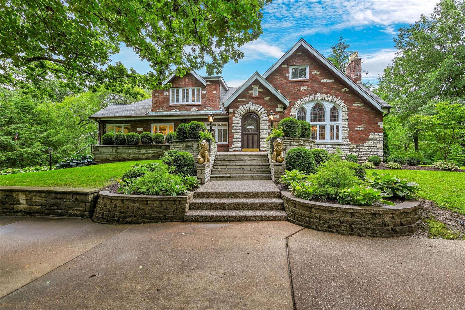 All Brick Tudor home in desirable Webster Groves neighborhood with in ground pool, beautiful updates, on a 1+ acre lot. Over 4,100 sq ft of functional living space with tasteful modern updates without taking away the original charm. The chef's kitchen was fully remodeled in 2018 & professionally designed by Karr Bick Design. The functional yet elegant eat in kitchen boasts custom cabinets, quartz countertops, stainless steel JenAir appliances, and a large center island. Karr Bick also designed the new main floor powder room and the bath for the main floor master suite. The master bath has a large walk in shower with heated custom tile floors & double vanity. 4 large bedrooms upstairs share a fully remodeled bathroom with easy access to the newly added 2nd floor laundry room. There is plenty of space in the finished basement for entertainment with large rec space and bar area. The in-ground pool and back patio space is the cherry on top of this entertainer's dream home.