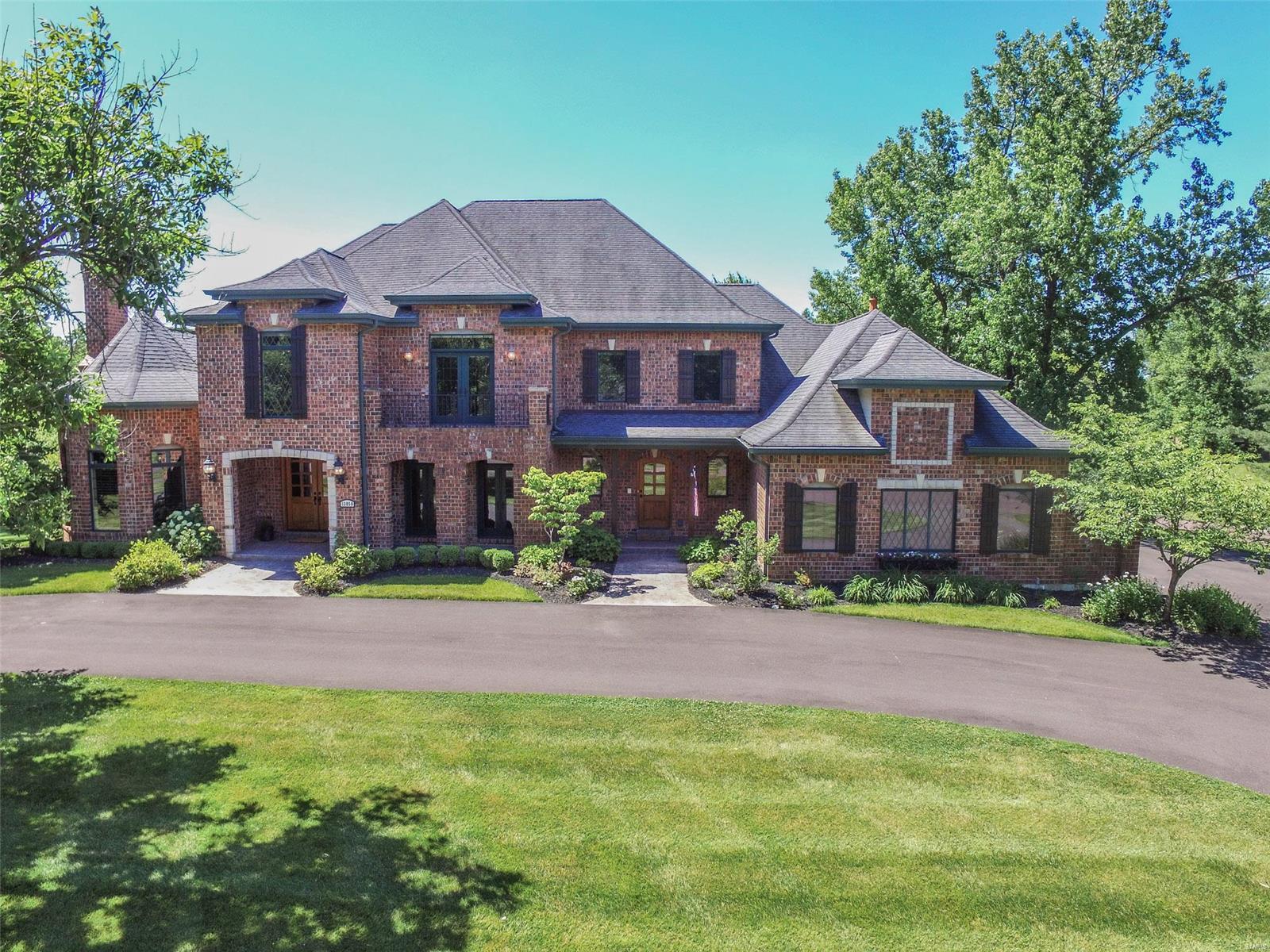 STUNNING LUXURY HOME – Over 8K fin. lvg. space - Highest quality amenities/finishes/appliances/ lighting/moldings, 5” wood floors, 8’ 2-panel doors, plantation shutters, 4 fireplaces; Impressive entry - marble floor, arched openings, curved staircase; Formal DRm - coffered ceiling/accent lighting; Den/office - custom blt-in desk, granite, pull-out features; GOURMET kitchen – granite, ctr island, 42” cabs, 6-burner gas Dacor range, wine cooler, ice maker, bar sink; 2-story LRm – wall of windows over pool; BFast Rm – French doors to patio; Hearth Rm – blt-ins, brick fireplc/stone mantel; Main flr MBR w/ sitting rm, 2 walk-ins, AWESOME bath – jet tub/spa/steam shwr; Upper landing + 3 BRs, walk-ins; INCREDIBLE LL: Theater Rm seats 8, sauna, exercise rm, billiards, bar w/ DW, ice maker, mini-fridge, 5th BR; Salt water pool w/ slide/heater, Kooldeck, pergola, brick fireplc; prof. landscaped; ALL NEW circular/side driveway, oversz 4-car garage; Subdiv. pool/tennis. Virtual & 3D tours online. COOL: 14 SEER+
