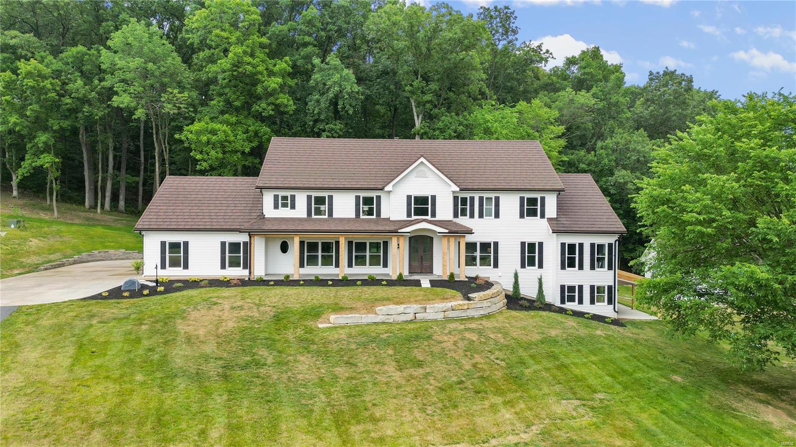 This stunning home has been extensively remodeled! 7700 sq ft of space on 4.8 acres and completely powered by propane & solar.  The beauty of nature surrounds you as you enter. Kitchen is a cooks dream with high end appliances including a warming drawer, gourmet range, Bev cooler and custom cabinetry. Walk out onto a brand new patio & screened rm w/automatic screens. Center island has a brkft bar and spacious eat in area.Dining rm is huge w/built in cabinet. Hardwood, new lights and tile throughout. The cozy liv area has a gas fp w/stone surround. The primary suite is grand with a see through fireplace, sitting area, custom closets/laundry & grand master bath w/custom shower/ soaking tub. Add 4 roomy bdrms (2 w/ensuite baths, 1 hall) lounge area & laundry rm. All baths are brand new w/tile floors, new fixtures and new tile work. 3rd floor is finished w/new carpet and ready for a media center. Basement is finished w/full bath, custom wet bar/cabinetry & walks out to secondary garage. Some Accessible Features Additional Rooms: Mud Room