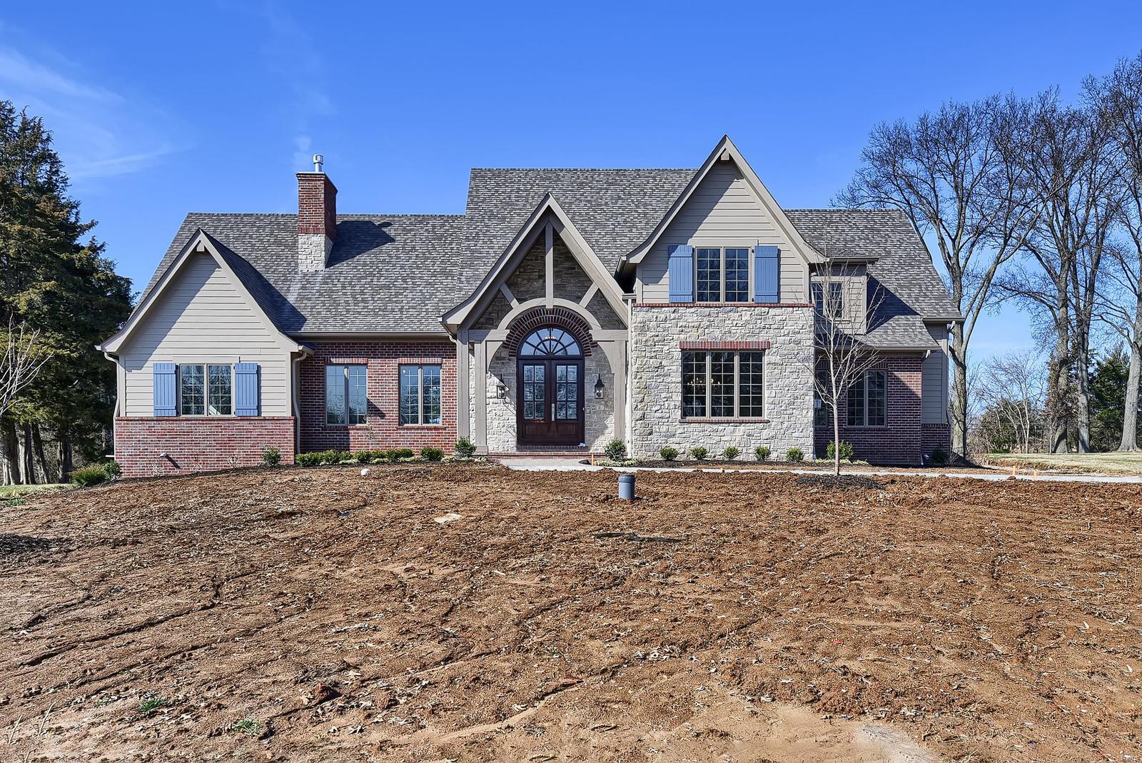 This home is nearing completion. The site is on a quiet, cul-de-sac street.  The backyard is long, wide, level & private. The home's exterior features soaring roof lines, a blend of stone, brick & painted siding, functional shutters & a distinctive timber framed front porch. The building footprint is not a box shape, but one that has numerous offsets for character & interest.  Some of the home's predominate interior features are hardwood floors, 8 arched openings, bull nose corners throughout; vaulted foyer & great rm ceilings.  The great rm features a floor to ceiling stone, masonry wood burning fpl & access to a part covered, exposed aggregate concrete patio.  The living rm, which serves as a get away rm, has an upgraded gas burning fireplace.  The kitchen area (which includes a breakfast room) contains 450sf and a 10' long island with prep sink. The lot is not a walk-out, but there are concrete stairs in the garage leading to the basement for easy access for future finish or storing