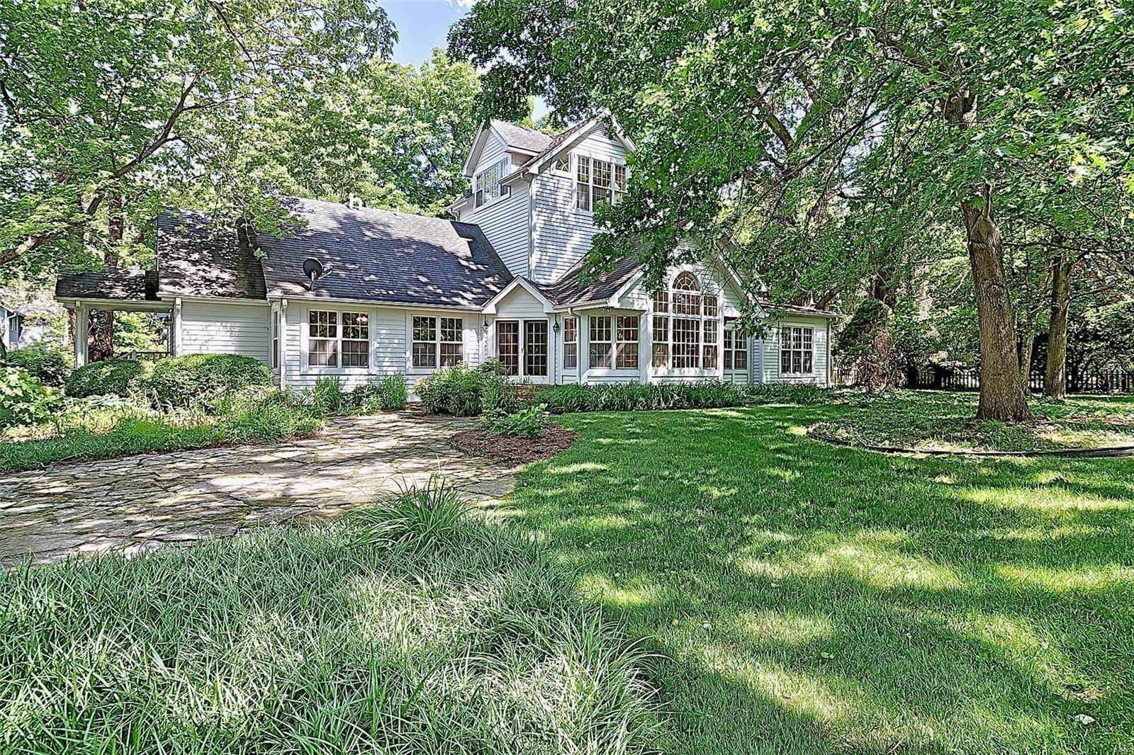 This lovely turn of the century home, originally part of the John P. Litzsinger estate, awaits your arrival and personal touch. The addition that was completed in the late 80's, early 90's created a wonderful space for gatherings. The addition includes a large eat-in light filled kitchen, family room, first floor master suite with fireplace and third floor guest bedroom or office with spectacular views of the property. The original portion of the home is filled with character, inclusive of the wood burning fireplace in the living room, wood floors, built-in bookcases, and original moldings. The acreage includes this beautiful home, pool with stone surround, guest/pool house, oversized two car garage  and more. The property is filled with native midwest trees and greenery, creating a beautiful private setting. Make this gorgeous nearly three acre parcel your next dream home location.