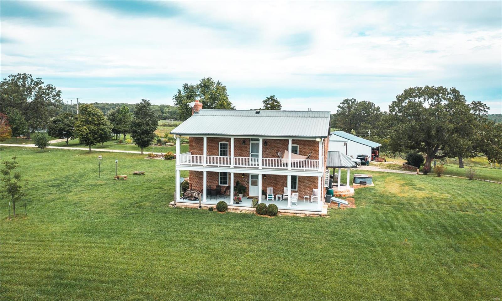 Brush Creek Farm is an absolute gorgeous property. The home sits up on a hill overlooking the fertile pastureland below & the fertile farm ground that is double cropped with beans & wheat. Brush Creek runs through the property & there are plenty of fish to be caught! In addition, the home was remodeled & is in excellent condition. This is a turn-key home! It was built in 1875 & completely remodeled by the current owner. The 2-story brick home has apprx 2880 sqft 4 bedrooms & 6 bathrooms. There is another kitchen upstairs in a game room that is great for entertaining. Also on the property is a metal pole barn for equipment and tractor storage and a huge wooden barn that has been restored to its highest potential. It could be used for hay, animals and additional storage. There's a ton of deer and turkey that live on and around this property. This property has it all, water, farmland, pasture, a beautiful home, timber and tons of wildlife! Come take a look before it's too late!