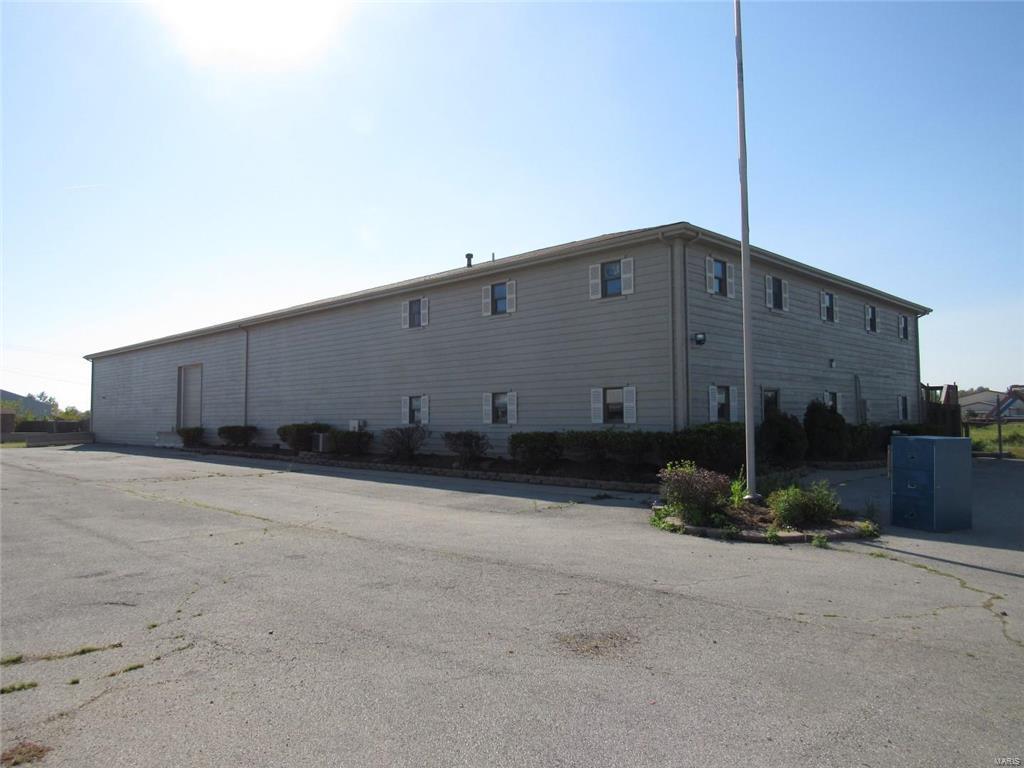 The property is zoned commercial and consists of three buildings on almost 7 fenced acres. The main building consists of approximately 13,033 s.f. that includes about 4,000 s.f. of office space and about 9,000 s.f. of warehouse and mezzanine space. The warehouse ceiling height is about 19 feet high with two overhead drive through doors(14' high, 10' wide). The outbuildings consist of a two car garage/storage shed and Metal warehouse with an attached Quonset building(about 50 x 105 and 21' high at the center point). The warehouse outbuilding is divided into three sections, concrete floors, two sections are heated with ceiling heights ranging from 13' to 20' high and have 5 overhead doors. The third section has concrete floor, 13-19' high ceiling and two overhead doors. Location: Industrial Area