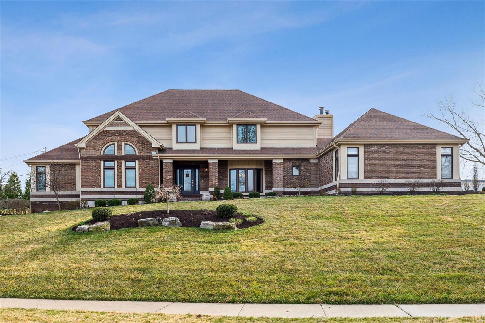 Indulge in luxury living in Ladue School district with this exquisite 1.5-story home! Over 5,000 sq ft of total living space, every detail exudes opulence. The main floor primary suite boasts 2 walk-in closets and bathroom with marble finishes. The updated kitchen features an expansive island and breakfast bar, overlooking a spacious hearth room with fireplace. Elegance abounds from the formal dining room to the vaulted ceiling living room/office. The 2-story family room is a showstopper with brick fireplace and wet bar. Upstairs, 3 bedrooms offer comfort, with a balcony overlooking the family room. Additional amenities include a main floor laundry, oversized 3 car garage, circle drive and over 1,200 sq ft of living space in the LL with a bedroom, full bath, rec room and wet bar. Outside, a newer patio with pergola and fire pit is perfect for entertaining. This home seamlessly blends luxury and functionality, offering a lifestyle of refinement. Welcome to your dream retreat!
