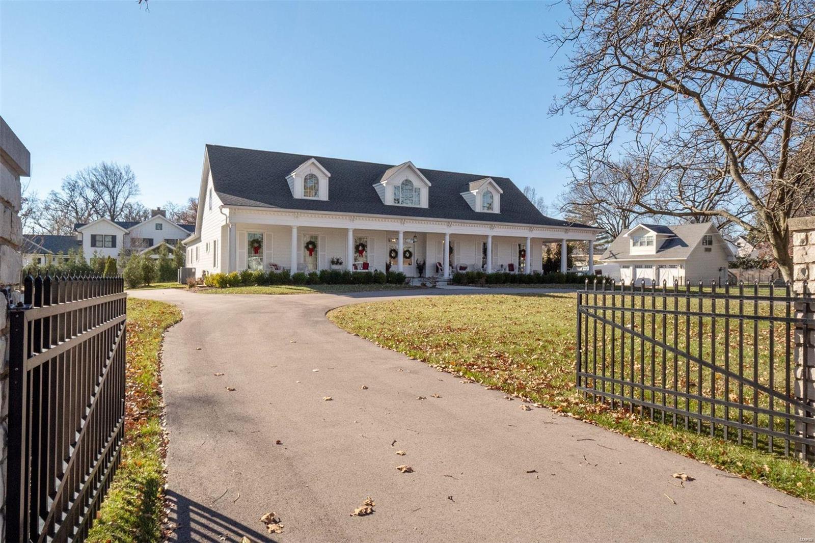 For the buyer who yearns for Old World charm minus the stress and uncertainty that often comes with homes “of a certain age”, this 2 year old custom build in the heart of Kirkwood's Monroe Historic District is the perfect option. The stone marquis, circle drive and the inviting wrap-around front porch present a grand first impression. Highlights of the main floor include a home chef’s dream Kitchen with stainless steel appliances, solid surface counters, beautiful glass front cabinets, and a walk-in pantry designed by St. Louis Closet Company; main floor Primary Bedroom with coffered ceiling, opulent ensuite, and dual walk-in closets; additional Bedroom/Office; hardwood floors; gas fireplaces in the Living Room and Hearth Room, and an inviting screened porch overlooking the private backyard. LL Family Room features an electric fireplace with stone surround plus a dry bar. 3 large Bedrooms & 2 full Baths on 2nd flr. Enjoy the close proximity to downtown Kirkwood and all it has to offer.