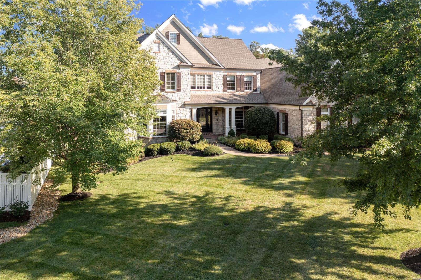 Nestled at the end of a private cul-de-sac, this stone crafted 1.5 story will be sure to impress. 2 story entry with wood flooring that leads to formal dining room. 1st floor office with glass French doors and private access to master suite. 2 story GR in the center of the home with fireplace, wood flooring and wall of glass to rear with fabulous views of rear yard and pool. Large custom kitchen with tons of cabinet and counter space, center island, gas cooktop, stainless appliances, walk in pantry, granite counters, and ceramic tile flooring that flows into the separate breakfast room and vaulted hearth room. Tons of windows with beautiful views from every angle. First floor master suite with lovely master bath, whirlpool tub/sep shower, dual vanities, dual walk in closets. Upstairs, 3 beds, 2 baths, and large open bonus room. Fin LL with rec, bar, fireplace, billiard, 5th possible bedroom and wine cellar. Gorgeous in ground pool with fireplace and grilling kitchen. Level fenced yard. Additional Rooms: Wine Cellar