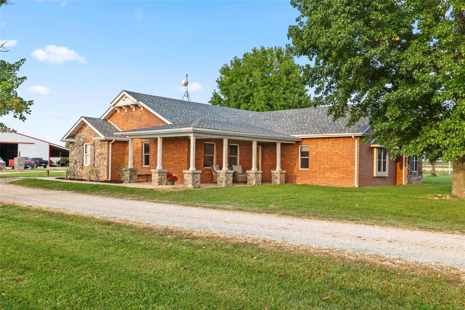 Ranch Paradise Awaits! This stunning 228-acre ranch, one of the finest in the area. The property showcases expansive hayfields, sizable pastures, perimeter and cross fencing, tire waterers, ponds, a year-round spring, and steel cattle working pens with an under-roof head chute. The impressive hay barn measures 60x105 with 30x135 lean-to to park all your equipment under one roof. In addition, it includes a 30x40 shop, a 30x64 four-bay machine shed. There are 47 acres of marketable timber, perfect for hunting in the box blind located on the back side of the property. This charming 2,000+ sq ft stone and brick home features 3 bedrooms, 2 bathrooms, a magnificent trophy room, and a beautiful fireplace. The home also includes a storm shelter, and a new roof installed August 2024.