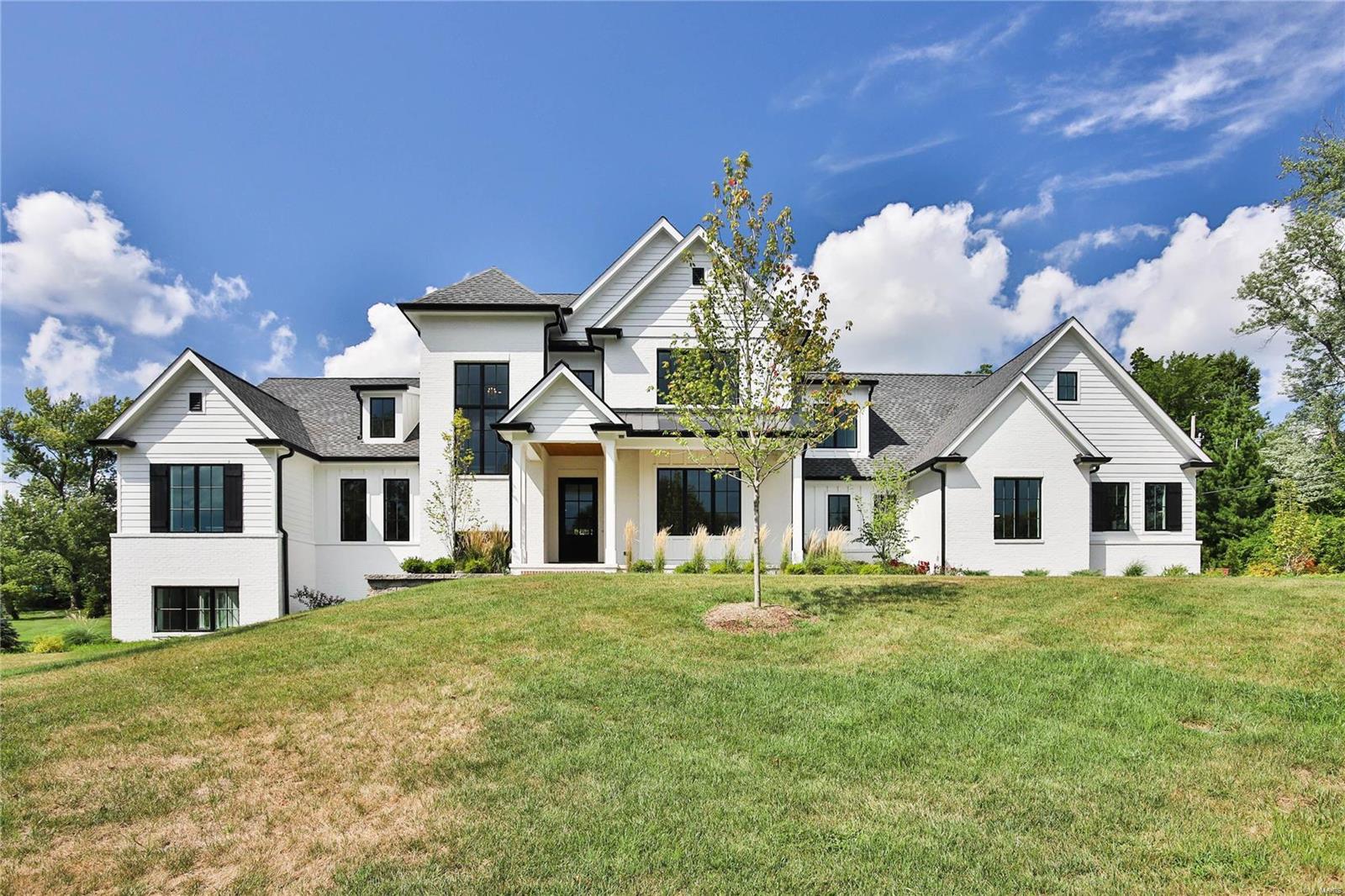 A light-filled new construction home on a large lot. Interior features include white oak flooring, custom cabinetry, white oak beams, 10' kitchen island, hidden pantry, barn doors, ship lap, 10' first floor ceilings, 9' second floor ceilings, and stair tower with paneled walls. Second floor has three bedrooms with en suite baths and a bonus area. Lower Level has large look out windows, a large recreation space, a guest suite, and a set of steps to the garage. COOL: 14 SEER+