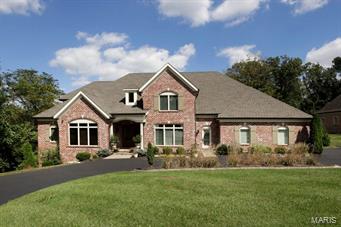 4-year old custom home on .81 acre property with main floor master suite and finished walkout lower level.  Very private cul-de-sac lot with plenty of room for a pool.  14' beamed ceiling center island kitchen with adjoining hearth room and wet bar shared with great room.  Wolf, Viking and KitchenAid appliances.  Master suite with 12' ceiling height, deluxe bath with Kohler air tub, granite, heated flooring and his & her walk-in dressing rooms.  Great room with 11' ceiling, fireplace and full elevation of windows overlooking the property.  Library with custom casework and dining room with butler's pantry.  2nd level with 3 bedroom suites plus bonus room/5th bedroom.  Finished walk out lower level with walk behind wet bar, full bath and bedroom 6. 10-14' ceiling heights on main floor, 9' minimum on upper level.  Main floor laundry, 3-car garage.  This house can accommodate any sized family.