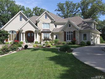 Amazing custom built home showcases authentic architecture and attention to detail. This unique home with over 8400 sq ft.features a striking Entry foyer with curved staircase. Elegant dining room. Living room/Den with french doors. Expansive great room. Plush main floor Master Suite and bath.  Gourmet kitchen & walk-in pantry. Kid-friendly mudroom with "lockers" & built-ins for their gear. 4 additional bedrooms with private,adjoining baths. Walkout lower level with Game room,Media room,Guest Kitchen,Built-in Bunk beds,Full bath,Dressing area, and additional Laundry. Amenities found throughout include wood, cork, tile and brick floors. Large Windows and an abundance of natural light. Custom Woodwork, Tile,Mantles & Built-ins. Soaring,beamed & coffered ceilings. Tall interior doorways & openings. Tons of outdoor living space includes a screened porch,2 outdoor fireplaces,swimming pool,sport court, detached garage, and circle driveway which are all surrounded by trees and privacy.