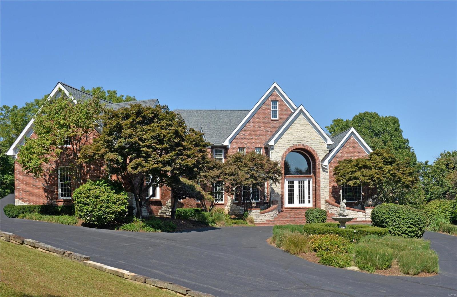 BACK ON THE MARKET - NO FAULT OF SELLER - Private gated luxury multi-acre estate. The ultimate in privacy & an entertainer's dream. Majestic 1 1/2 story w/ volume ceilings & open floor plan. Palatial entry w/ pillars, library, Brazilian Cherry floors & great rm w/ wall of windows. Expansive kitchen w/custom cherry cabinets & gas cooktop opens to vaulted hearth room w/ floor to ceiling stone FP. Private primary suite boasts tray ceiling, shutters & bath w/ spa like amenities, inc body sprays & dual shower heads, double jetted tub, built-in cust closet. The LL offers massive entertaining area, inc media room, exercise room & custom wet bar. Top of the line new carpet on main & upper levels. Spectacular pool & hot tub w/ Bright PebbleTech finish. Pool has beach entry, infinity edge, waterfall & baja seating. Flagstone & aggregate concrete surround pool, which overlook private wooded acres. Lush landscaping surrounds area w/ built-in gas grill & fridge. 4 car oversize gar. Additional Rooms: Sun Room