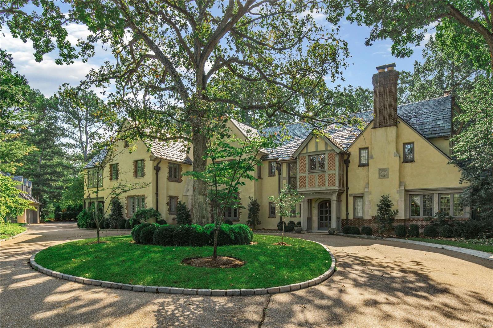 FABULOUS NEW PRICE!! This spectacular, architecturally significant home sits on two park like acres on Country Club Grounds. Beautifully renovated in recent years, the floorplan is perfect for entertaining! The gracious entry sets the tone, with three sets of french doors to the terrace and pool. The living room has fabulous windows, an elegant fireplace and opens to a cozy sunroom.  The lovely dining room has a fireplace and also opens to the terrace. The updated kitchen boasts Subzero and Dacor appliances and the Butlers Pantry adds casual dining space. The antique bar and oversized game room in the lower level add to the entertaining space. The upstairs is a treat starting with the spacious master suite with fireplace, large updated bath plus dressing area or office. The 4 additional beds are impressive (2 of them have fireplaces) and all have abundant closet space. There is a delightful suite on the first floor for guests. Four car garage with charming carriage house above.