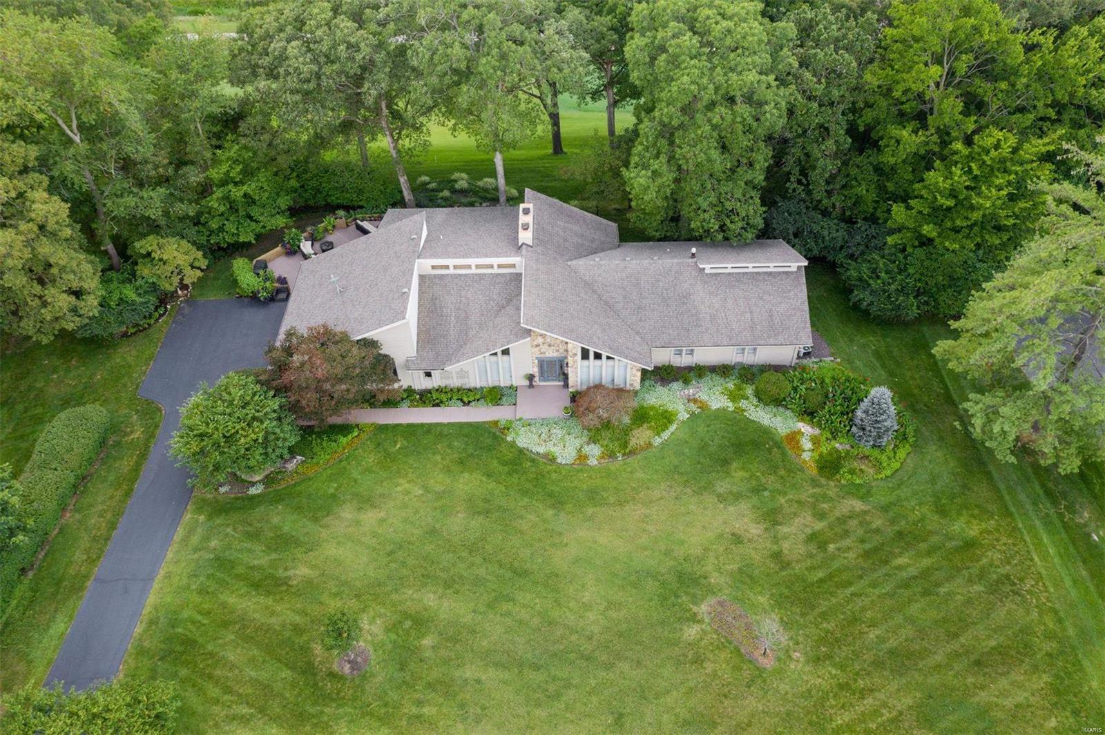 Sophisticated, stylish, classy & comfortable describes this updated California Modern Ranch in the ever-so-desirable Forest Hills Club Estates. Amazing view of the 11th green, 17th tee box & entire 16th hole of the Championship Course from nearly every room, w/ multi-tiered patio designed to enjoy every shot! The floor plan is open & bright, featuring the most amazing great room and kitchen w/ custom cabinets, granite tops, designer lighting, center island w/ smooth cook top & wall of windows overlooking the custom landscaped yard and golf course. Opens to dining room w/soaring ceilings and elegant fireplace. Glamorous master suite w/vaulted ceiling, relaxing bath w/dbl sink, garden tub and shower. Three other spacious bedrooms on main floor, updated baths and oversized garage. Finished WO LL w/ two TV rooms, game room, bar, workout space, full bath and bedroom. Easy walk or quick golf cart ride to club house. Country Club living at its finest!
