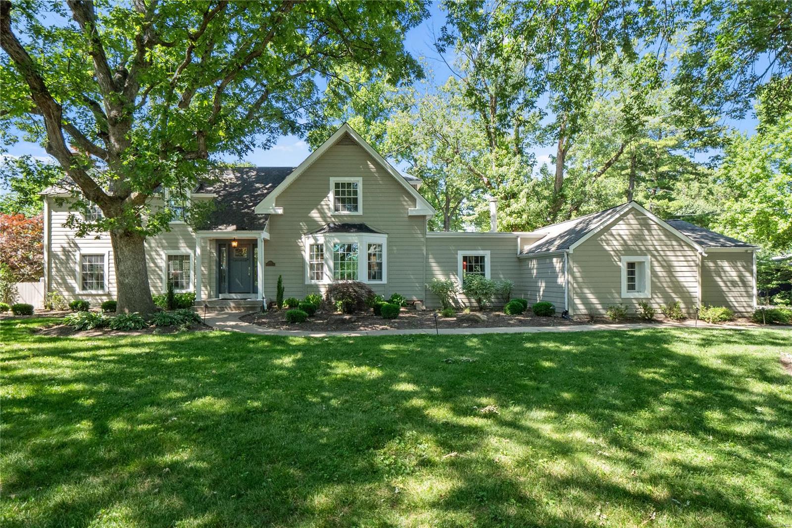 Nestled on a large private lot, this New England colonial feels like you’re in the countryside, while only minutes from DT Clayton, airport and all that St Louis has to offer.  Rich in details, this home has been carefully maintained and updated over the years to compliment today’s lifestyle.  A neutral color palette, rich hardwoods, designer finishes and abundance of natural light make this the perfect backdrop to live your best life.  The main floor contains multiple living spaces, large dining room with direct access to a carefully planned chefs’ kitchen with custom inset cabinetry, Wolf and Bosch appliances, 2 sinks, etc.  A main floor bedroom, full bath (which also serves pool) and half bath complete first floor.  The second floor hosts the master suite with fireplace, 2 additional bedrooms and JNJ bath.  The outside is an entertainers dream with mature landscape, large patio areas and a pool as the centerpiece.