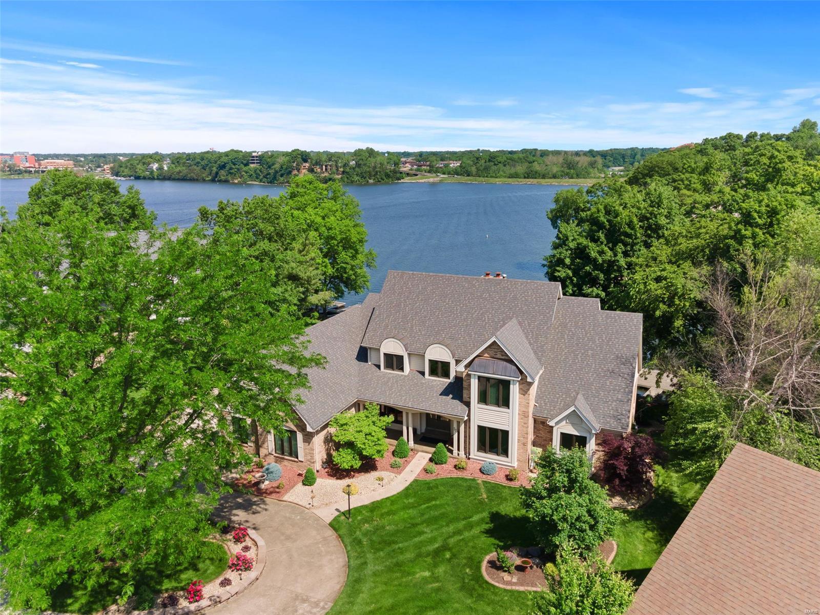 Executive WATERFRONT home situated on a premier lot in Easternshore Estates. Enjoy views of the lake from almost every room or on the composite deck that walks down to the large backyard and private dock. This stately 1.5 story boasts fabulous curb appeal with lush landscaping and a circle drive with side entry garage. Inside you are greeted with a 2-story entry foyer and staircase with iron spindles opening to the vaulted great room with beams, wet bar, brick fireplace and French doors leading to the sunroom. The chef’s kitchen features custom staggered cabinetry with crown molding, large island, walk-in pantry, and breakfast room with panoramic views. Retreat to the spacious master suite with a private deck overlooking the lake, his & hers closets with built-ins, jacuzzi tub and dual vanity. Entertaining is a breeze in the updated walkout basement complete with multiple living areas, large wet bar & full kitchen. This is one of the best spots to watch the CA fireworks! Additional Rooms: Mud Room