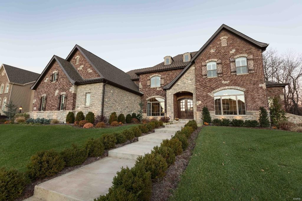 Designer Showcase 2 year old Custom 1.5 story home situated on the perfect homesite. Every little detail carefully selected. A grand staircase with open treads and riser as well as iron spindles will make a great first impression for your guest.  Flanked by a private study w/ built-in cabinets and shelves.  2 story Great room with full masonry fireplace w/ raised hearth and Timbered mantel. The gourmet kitchen with 10’ ceilings is equipped with a custom wood top center island w/ bar overhang, architectural 42”cabinets w/rope inlay crown molding, SS appliances, granite countertops.  Breakfast room has, brick/stone and timber wall accents. Vaulted hearth room Includes timbered headers, ridge beam, raised hearth stone front fireplace & French doors leading to the outdoor living room.  The main floor master bedroom suite includes: bay window, dressing room for her & large walk-in closet for him. French doors lead to the master bathroom with Jacuzzi tub and separate 9’ shower with 5 heads.
