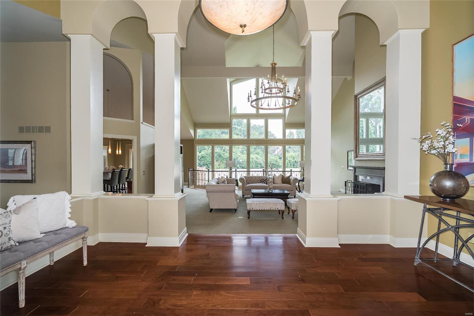 Spectacular ranch style home located in prestigious Creve Coeur! Open floor plan features distinctive design throughout including soaring ceilings, expansive windows & custom built-ins. Impressive Brazillian Cherry Hardwood foyer highlighted by architectural columns leads to stunning great room w/dimensional ceiling & dramatic wall of windows. Designer kitchen w/42" cherry wood cabinetry, granite countertops, premium appliances built in, walk in pantry, under counter lighting which adjoins breakfast room w/vaulted ceiling & newer sliding door to composite private deck. Master bedroom suite with gorgeous vaulted ceiling & stairway to private sitting area, plus a 2nd bedroom, full bath & a study/office complete the main floor living area. Gorgeous atrium staircase leads to W/O Lower Level w/frpl. family rm. game rm. rec. rm. 2 more bedrooms or workout rm. all on 1 acre cul de sac lot w/patio OVERSIZED 3CAR REAR ENTRY GARAGE
