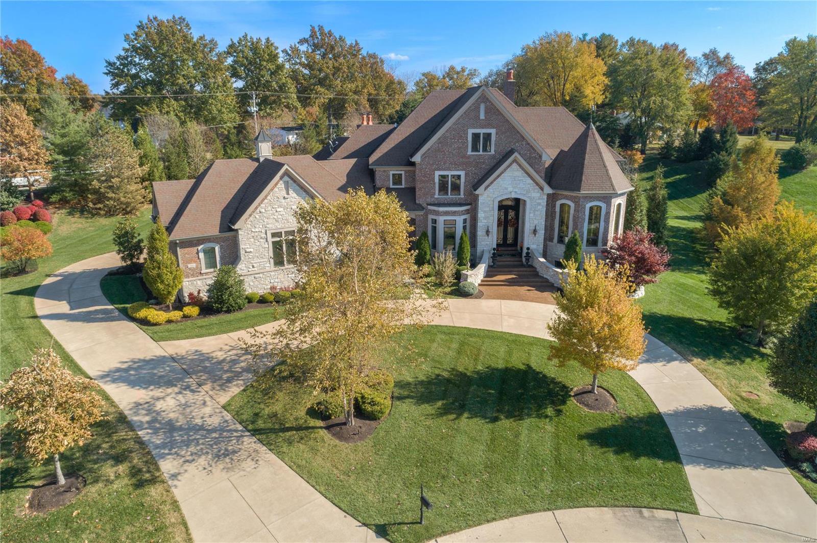 Gorgeous custom executive home in prestigious gated Devonworth.  Nestled on a premium 1.53 acre lot, this home offers keen attention to detail, and high end finishes throughout the sprawling 8000+ sq ft of living space.  Find a luxury main fl master suite connected to the library/den via a private wet bar.  The formal din and liv rms give way to the high end open custom kitchen with Subzero, Viking, Walker Zanger backsplash and more.  A fam rm/hearth rm opens to a walk behind bar.   Two powder rms and custom mudrm complete the 1st flr.  The 2nd flr offers a kids loft and 3 generous bedrm suites.  Perfect for entertaining, the low lev greets guests with a 2nd fam rm w fp, custom bar with Viking refrig and wine cooler, a  gym, billiards rm, 5th bedrm suite and full bath within a short distance walking out to the pool with integrated hot tub.  The real showstopper is the lanai featuring a liv rm with gas fp, and kitchen, all overlooking the landscaped lawn, pool and waterfall.  Perfection Additional Rooms: Mud Room