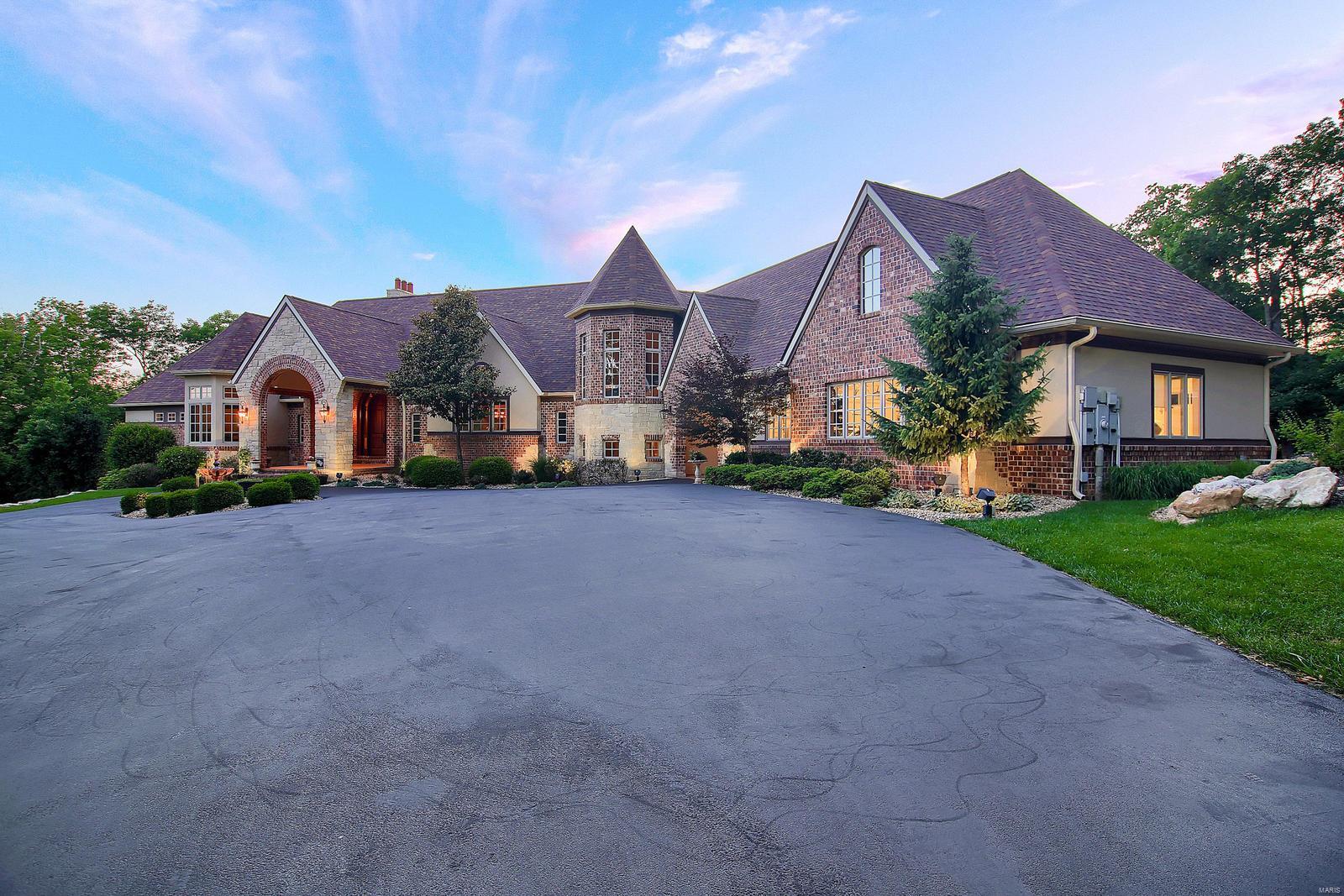 Enter through your own PRIVATE GATE to find the most STUNNING PRIVATE residence situated on 3+ lush acres in all of St Louis County. Walk through the MAHOGANY doors and welcomed to EXTRAORDINARY craftsmanship, superb architectural finishes and integrated systems, this 5 bedroom, 7 bath castle is an Entertainment Mecca. Chef's Kitchen, adjoins breakfast and hearth room, has custom cabinetry, large center island, Sub Zero Fridge, warming drawer, 6 burner gas stove, Dual ceramic sinks, and walk in Pantry. Master Wing includes an Executive Office and Master Bedroom Suite which includes; His and Hers Closets, Resort style Master Bath with His and Hers Vanity, Walk in shower w/8 Shower Heads and INFINITY soaking tub. The Main Level is complete w/Bedrooms 2 and 3. Upstairs is finished W/Mother in Laws Quarters. Walk-Out LL has a 2ND KITCHEN, 4th bedroom, Billiards Space, Bonus Room would be great for wine cellar OR Theater Room, and Custom Free form POOL with Water Features and LED Lighting. Additional Rooms: Sun Room