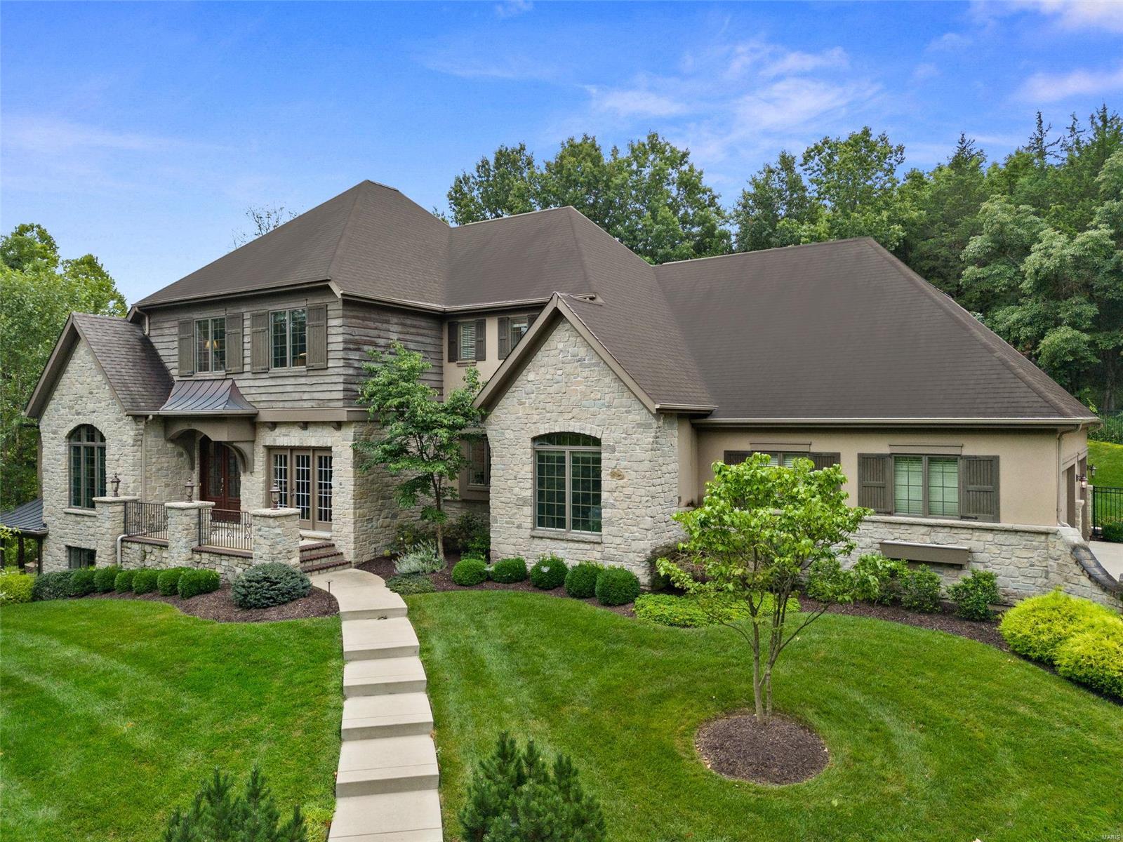 Welcome to this extraordinary custom-built Flower home, perfectly situated on 3.68 private acres within a prestigious Rockwood school district. The moment you enter, you're greeted by a grand curved staircase and soaring cathedral ceilings, beautifully complemented by wooden beams that add warmth and character. The heart of the home is an impeccable kitchen featuring stunning countertops, custom cabinetry, and a designer hood, all of which were highlighted in *Ladue Magazine*. This 5-bedroom, 6-bathroom masterpiece offers expansive, light-filled living spaces designed for both intimate family moments and large-scale entertaining. Retreat to your private outdoor sanctuary, where a luxurious saltwater pool and an inviting patio await, perfect for alfresco dining or lounging under the stars. This estate embodies elegance, comfort, and unmatched craftsmanship, making it the perfect place to call home. Additional Rooms: Mud Room