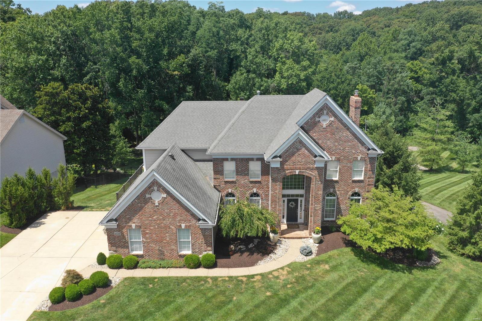 One of a kind 2 story home w/ over 5,800 sq ft of living space on a private, half acre lot backing to trees & situated on a cul de sac. Stunning  2 story entry hall that leads you to a formal dining room that shows like it just came out of a magazine. Cozy family room has a gas fireplace & large bay window. You'll love the kitchen, it's open to several other rooms for entertaining & features custom cabinetry, quartzite countertops, Monogram stainless steel appliances, a walk-in pantry, a breakfast bar, and a bar for entertaining. The hearth room is a decorator's delight w/ an incredible gas fireplace. You'll enjoy a large composite deck to overlook your sprawling yard. Upstairs you'll find more hardwood floors & four spacious bedrooms including a fantastic primary suite w/ a new bathroom. New roof, gutters, and water heaters installed August/September 2023. Additional Rooms: Mud Room