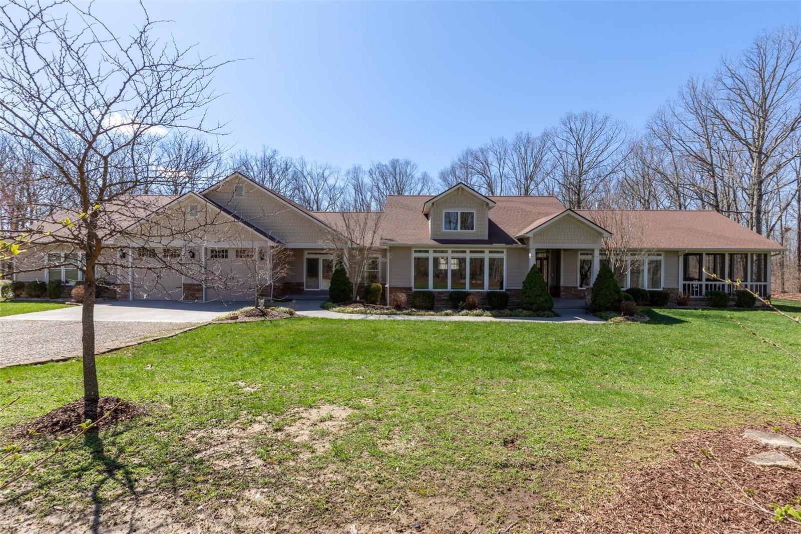 Tucked away and secluded, 401 Kapper Lane is located on 42.5 acres of natural Midwestern beauty with woods, pastures, and a glimmering pond. With five bedrooms, six and a half baths, and numerous indoor and outdoor amenities, this 6,100 square foot Craftsman is truly a hidden gem of the Heartland. Undisturbed and secluded, it offers a welcome retreat from the noise and chaos of the city.  The sprawling grounds and spacious rooms make this property perfect for corporate retreats, family gatherings, or perhaps a couple or family looking to enjoy the austere beauty of the Midwest.  Once inside, you’ll be stunned by the high-ceilings, luxurious amenities, and spacious rooms. Throughout the home, you’ll see well-maintained hickory, pine, ceramic tile, and carpet floors. If you enjoy woodworking, then you’ll be thrilled to know about the woodworking shop. With central heating and cooling, you can work comfortably for hours. Are you ready to call this oasis home?