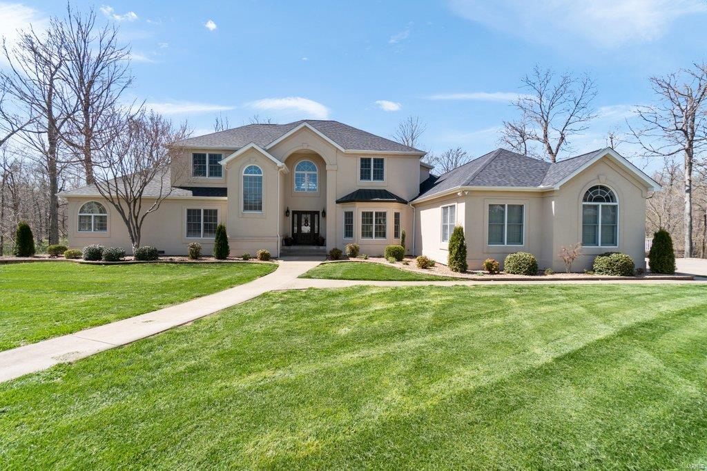 Exquisite custom home located in a quiet cul-de-sac at Windwood Lake Estates.  This home is surrounded by mature trees with an exceptional view of the lake! Once you enter the front door, you will fall in love with the two story entry way and all the natural light that flows throughout the entire home.  The vast, open first floor boasts a Kitchen with stainless appliances, elegant dining area that is great for entertaining.  The master suite has a gas fireplace, sitting area and master bath that is spacious and has two custom walk-in closets. When you enter the newly renovated lower-level, you will be drawn to the various living/entertaining spaces available...be sure to check out the beautifully designed wine conversation area where you can display your wine, spirits or any other prized possessions. From the main floor or lower-level you can step outside and become one with nature on the custom stone patio overlooking the lake...Absolute Paradise!