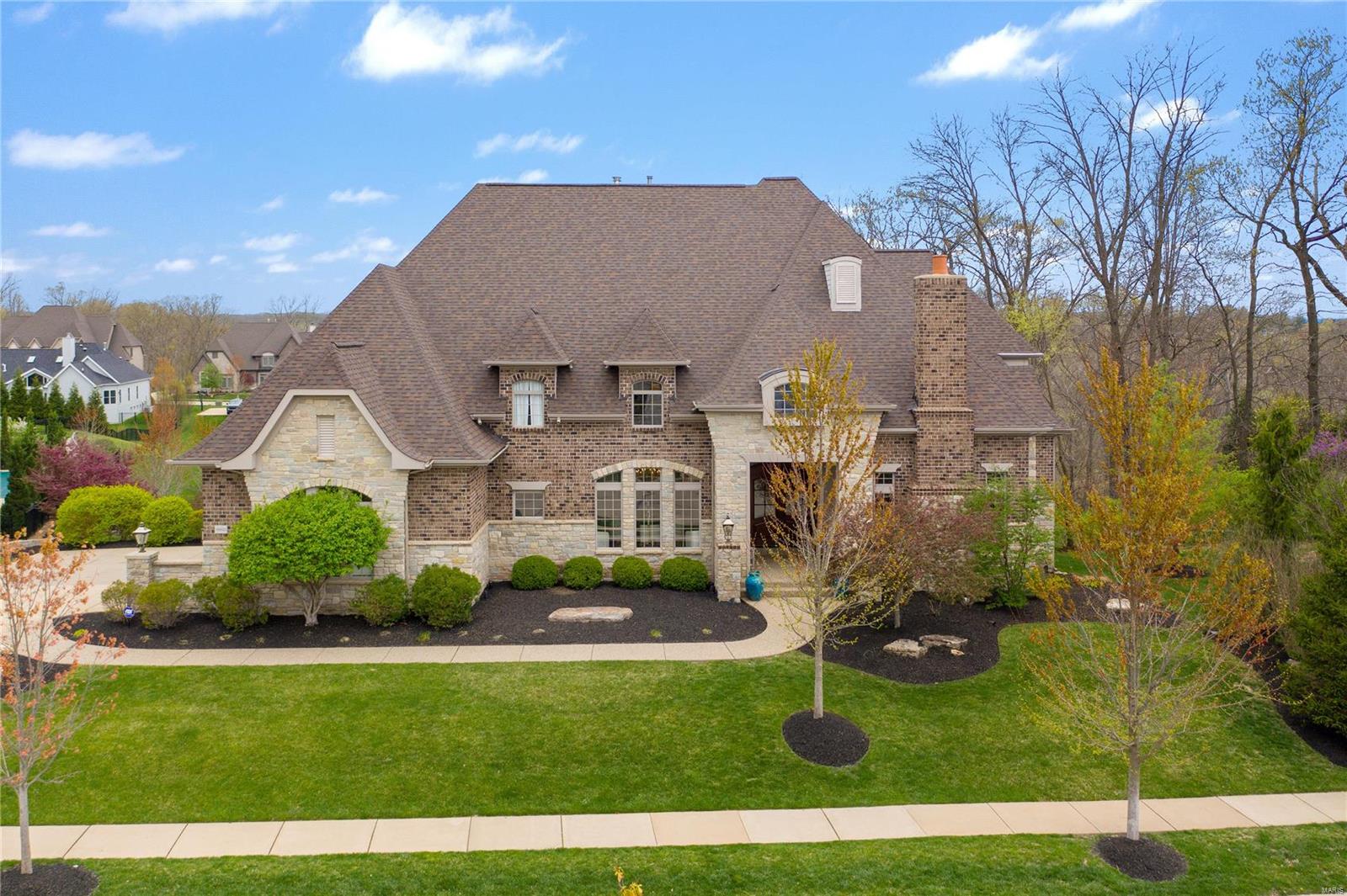 Beautiful former display home built by Simon Homes in Fox Hill Farms! Spacious and loaded with fine upgrades. Hardwood flows throughout the main living areas. Stunning woodwork including a beamed ceiling in the home office, wainscoting, crown molding and gorgeous trim. Fantastic great room with 20-ft ceiling, wet bar, floor-to-ceiling windows and a gas fireplace. Huge kitchen/hearth room with top-of-the-line appliances, large center island, custom cabinets, vaulted ceiling and opens to charming screened porch. Front/Back stair floorplan leads to three room UL BRs and two full baths. The walk-out finished lower level is one place where everyone will want to hang out. The rec room offers new carpet, fresh paint, wet bar and a fireplace. The two-level media room features surround sound, 4K projector and 100-inch screen. Don't miss the massive home gym with Nike rubber flooring and a water fountain! Sonos whole house sound system. Huge 1-acre lot provides option for future inground pool.