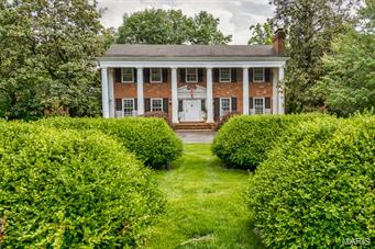 Immediately you will be drawn to this pillared Ladue home on 1.19 acres. The front porch is gracious & will make you feel like you are at a Southern estate home. The front foyer, Living Room & Dining Room feature intricate millwork. The kitchen boasts a 6-burner Viking stove, Sub Zero refrigerator, dual ovens, granite counters, custom wood cabinets & a breakfast room w/bar that leads into the wood-paneled family room. Fireplaces in the Living Room & family room. The master bedroom has a walk-in closet with custom shelving & an updated bathroom with dual sinks. Doors from the breakfast room lead to a covered porch & a large patio.The custom T-shaped pool is newer & features a 20-meter swimming lane, large shallow end, fountains, Cool Deck & heater. Large, deep, private yard. Finished Lower Level w/walkout, media room, 300 bottle, temperature controlled wine closet, granite-topped cabinets & 1/2 bath. 3-car attached garage. Trails End residents have a private entrance from Litzsinger Rd.